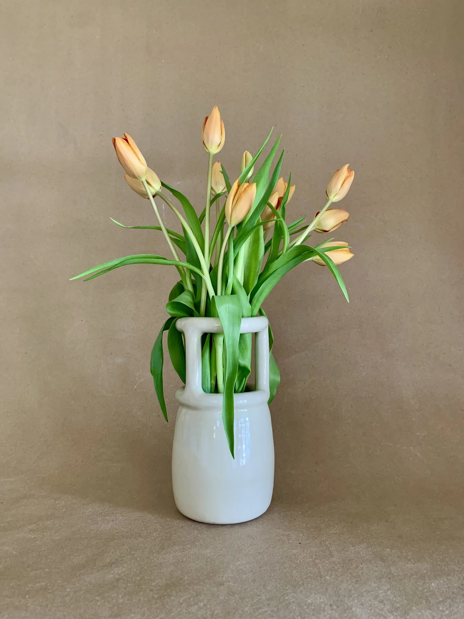 Trellis Vase holding a bouquet of orange tulips