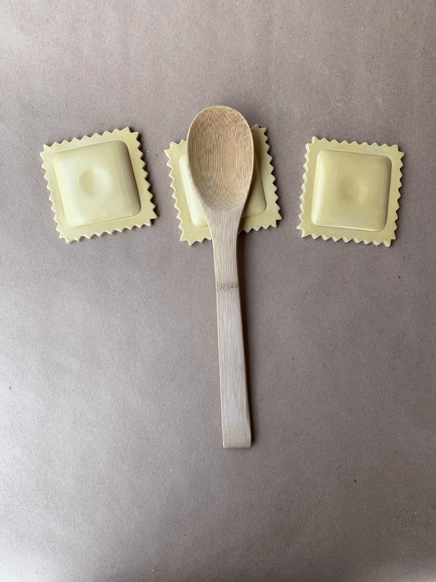 Ravioli Spoon Rest, ceramic spoon rests shaped like ravioli pasta with a wooden spoon