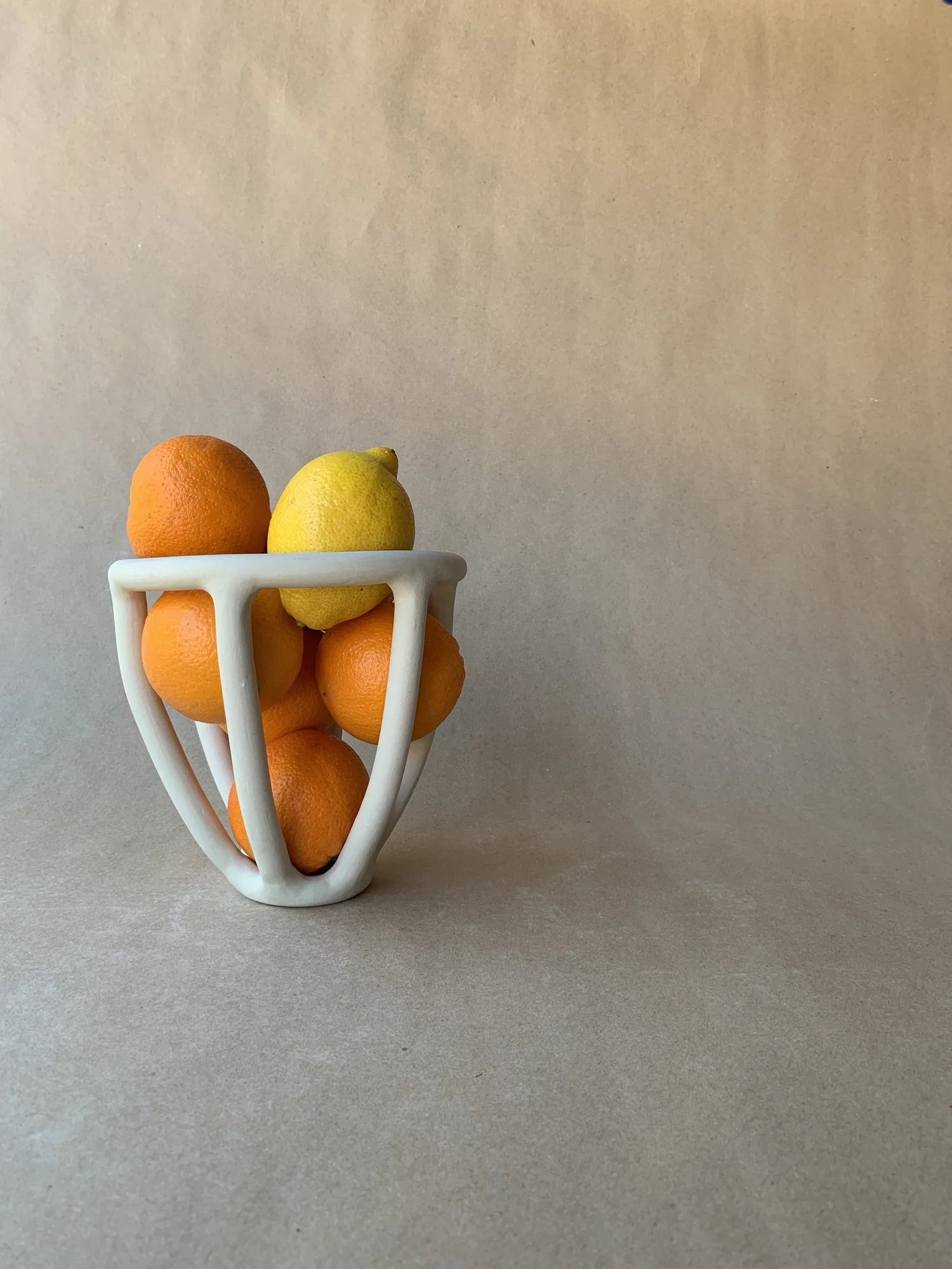 Fruit Basket, small cone-shaped ceramic basket holding oranges and a lemon