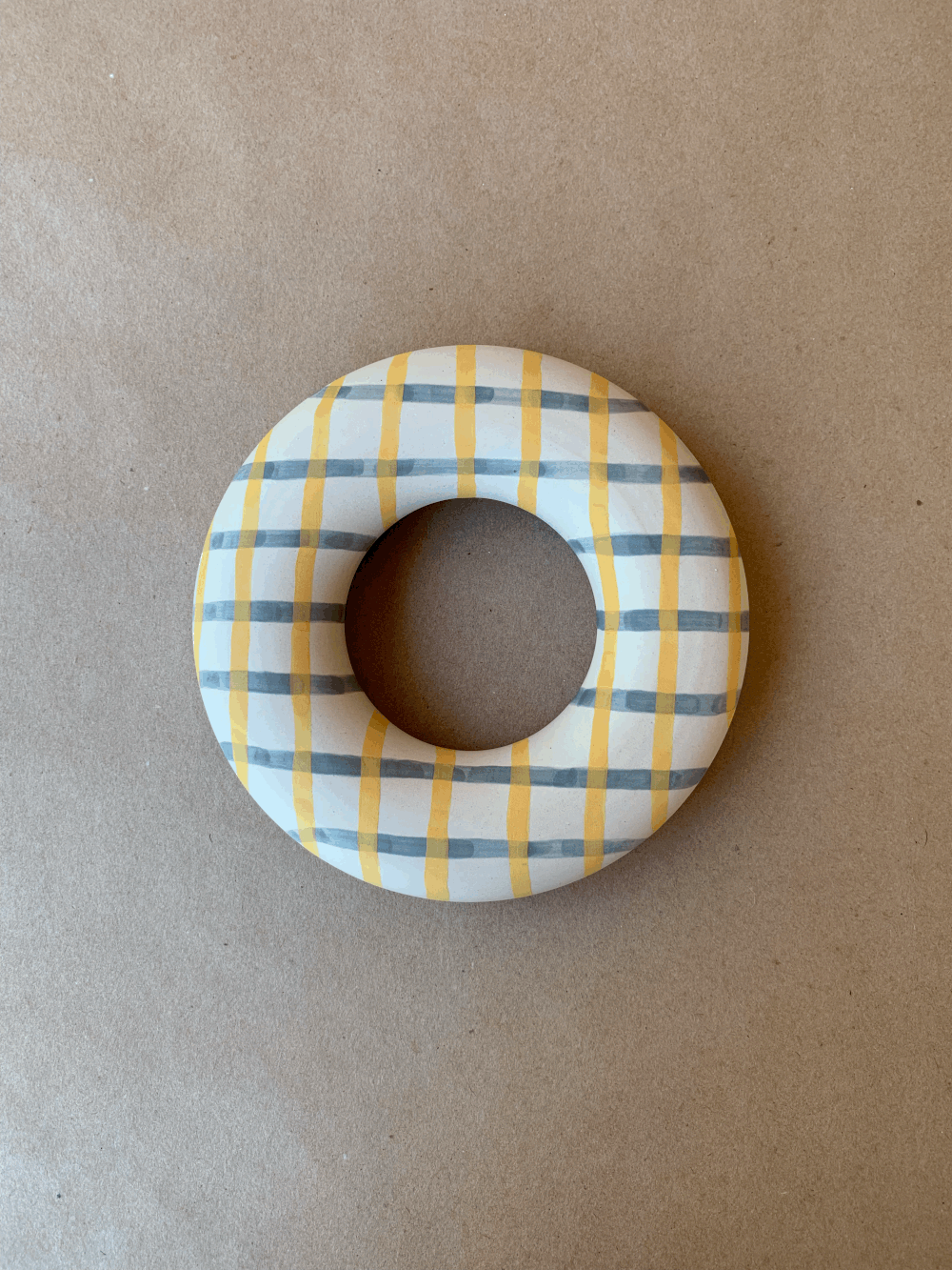 Handmade gingham-patterned circular ceramic piece by Ware Ware Studio