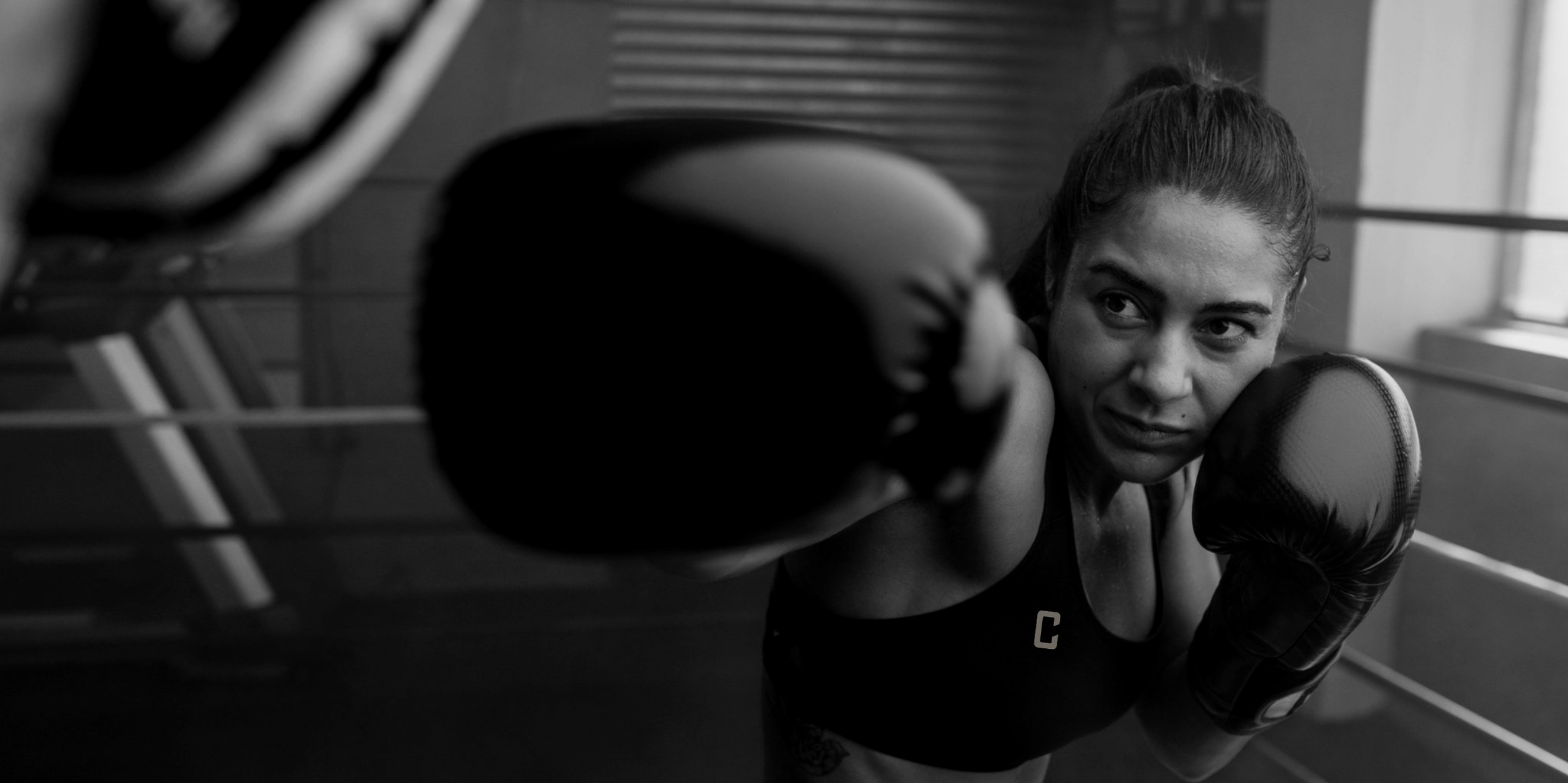 Female Boxer Throwing a Punch while in the boxing ring
