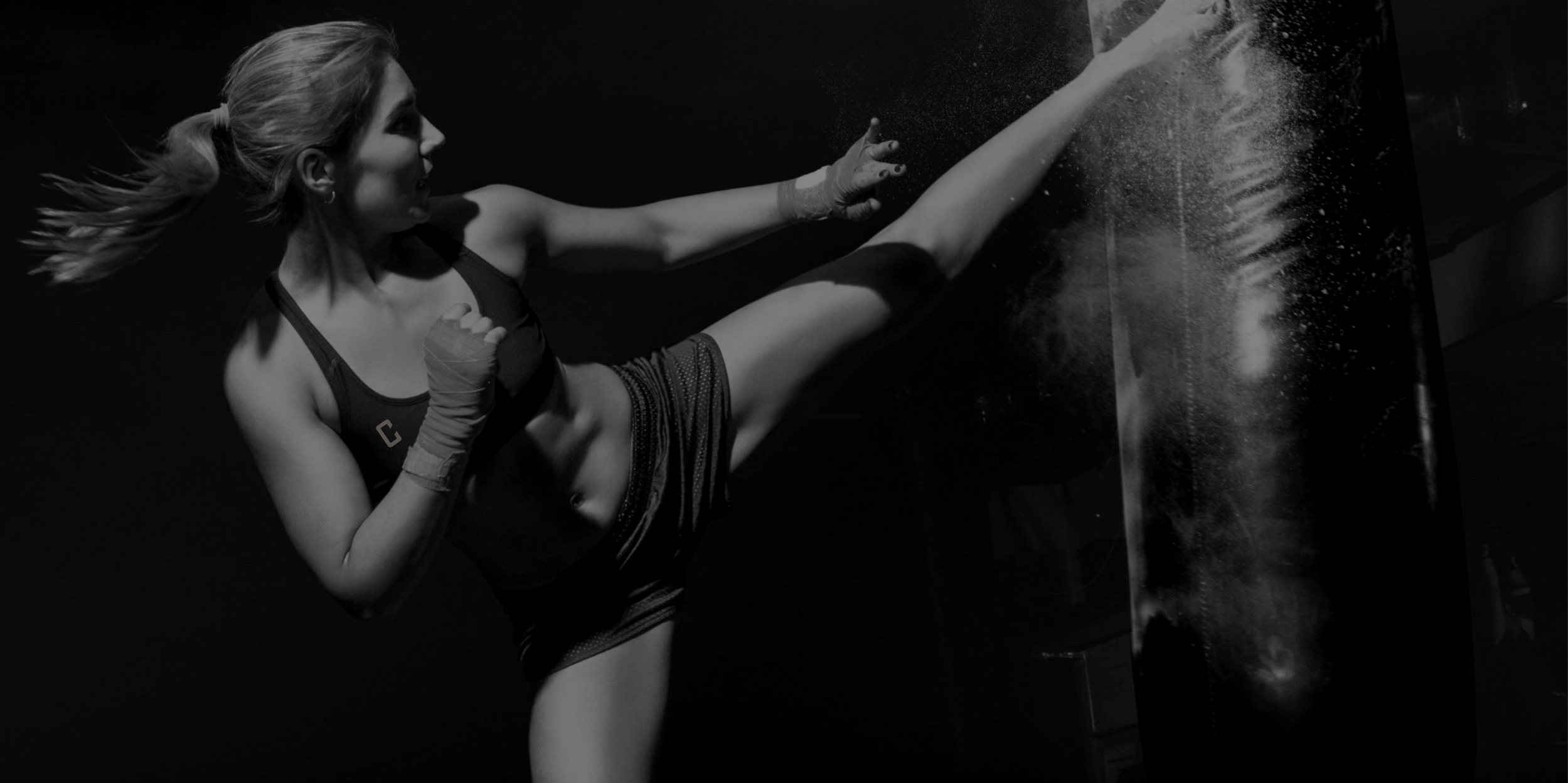Female Fighter Kicking a heavy