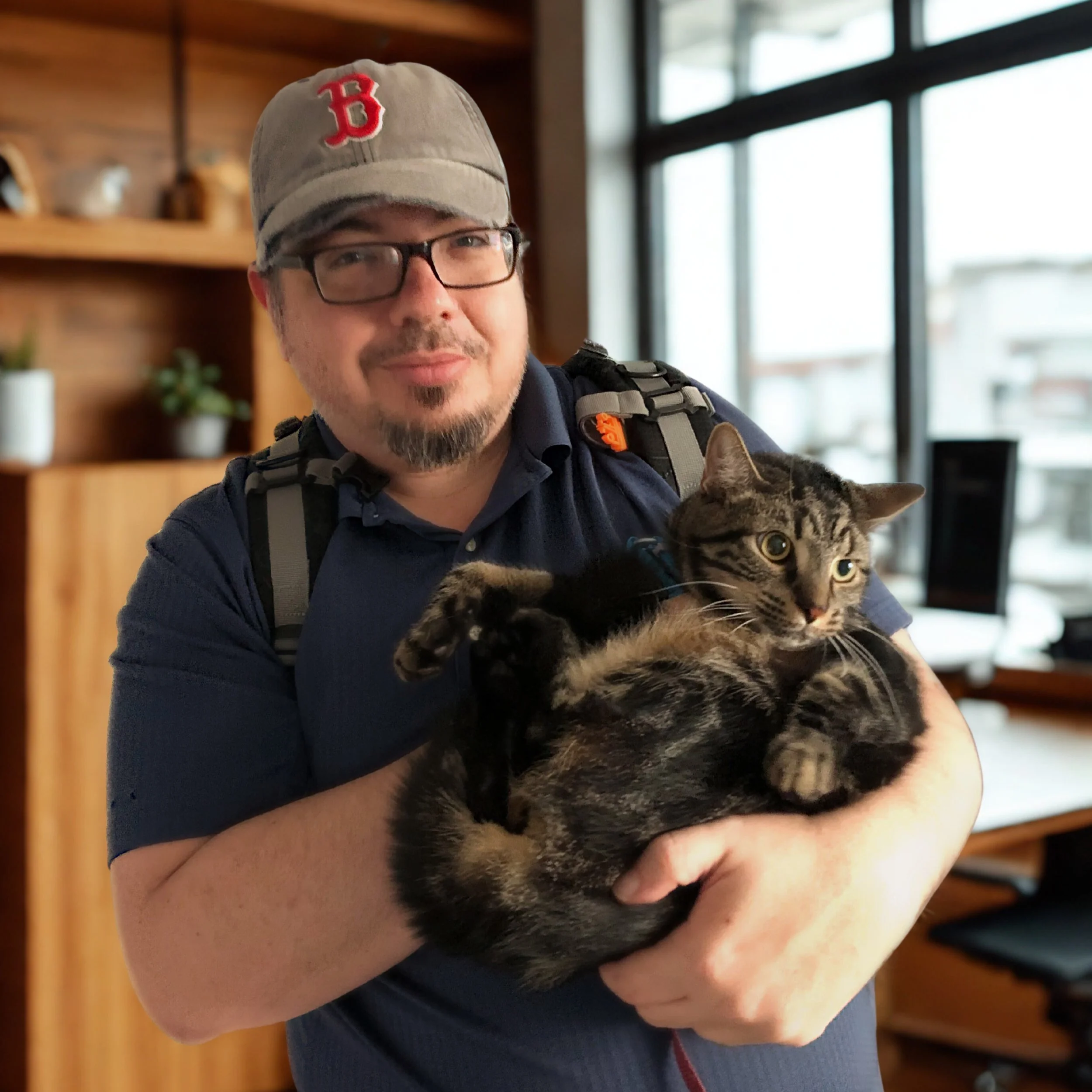 Photo of Good Karma director Byron Torre, man holding a cat