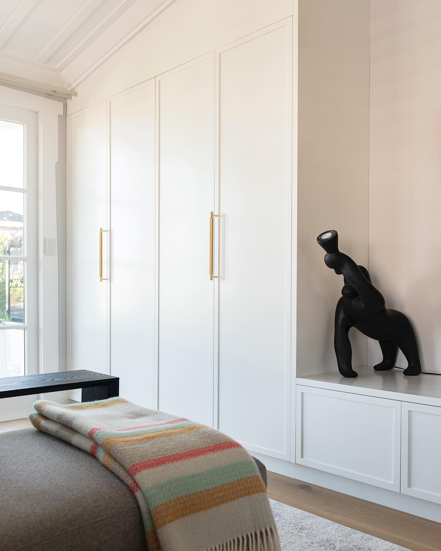Adding a built-in storage wall in the kids living room keeps those games and toys stashed away (in an ideal world that is!). Adding a false panel at the top to meet the angled ceiling makes it feel more built in, and continuing the cabinetry under th