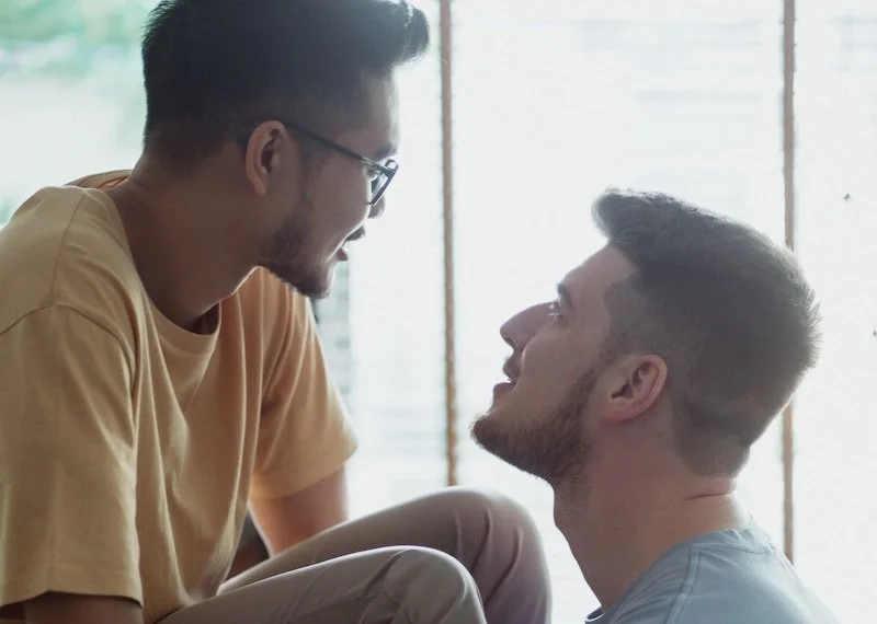 Boyfriends looking at each other in a discussion