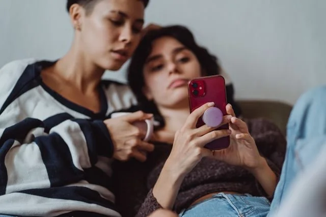 Two women looking at a smart phone
