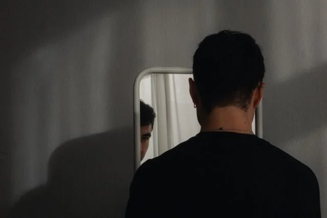 a person looking in a mirror