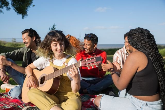 a bunch of friends sitting around playing guitar