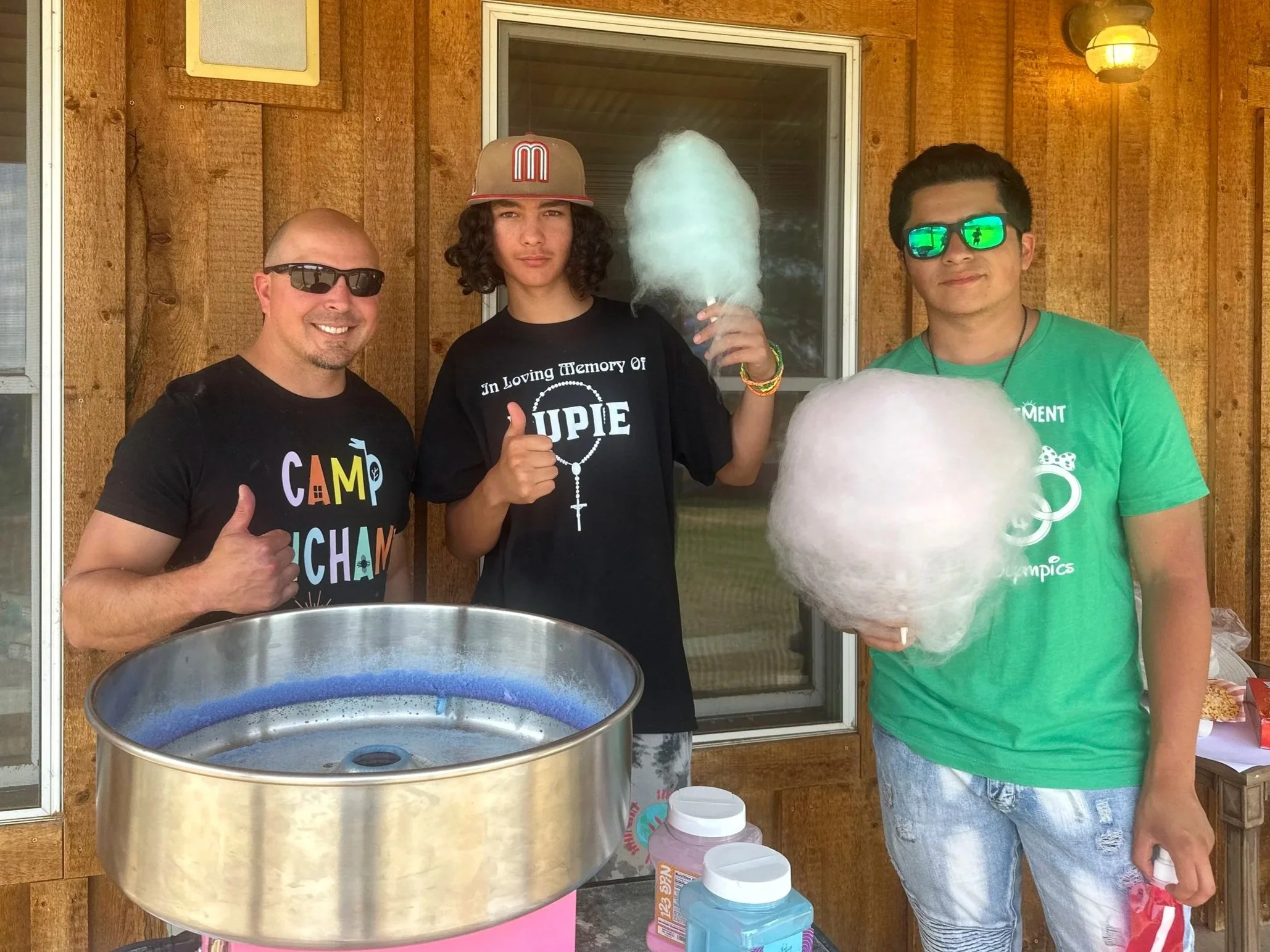 Camp Enchantment Board member serving up cotton candy and fun to campers