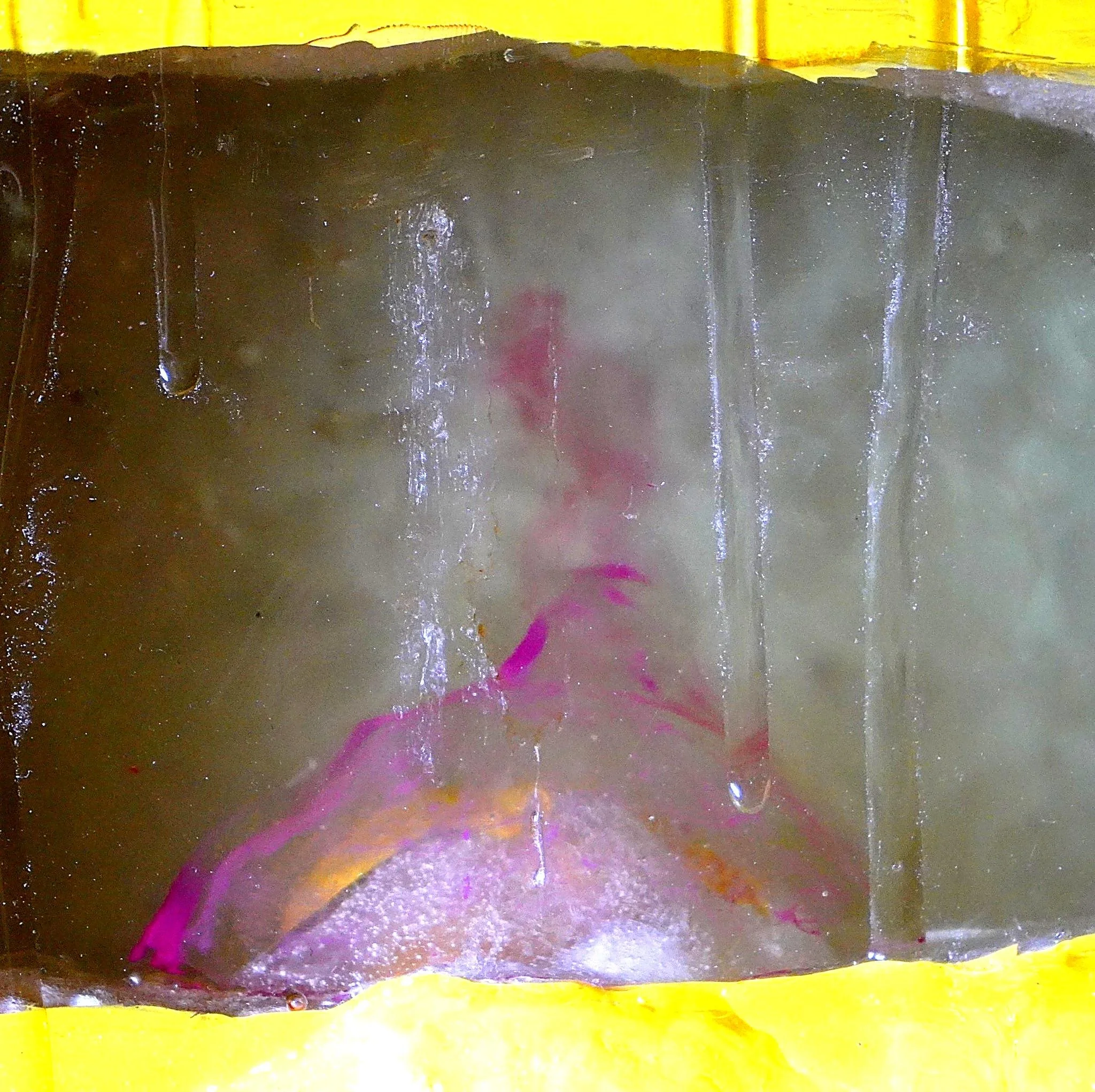 Detail view of Volcanic Shelf sculpture by contemporary artist Sophia Huang, mixed media shelf sculpture with resin, paint, and embedded objects, abstract melting form