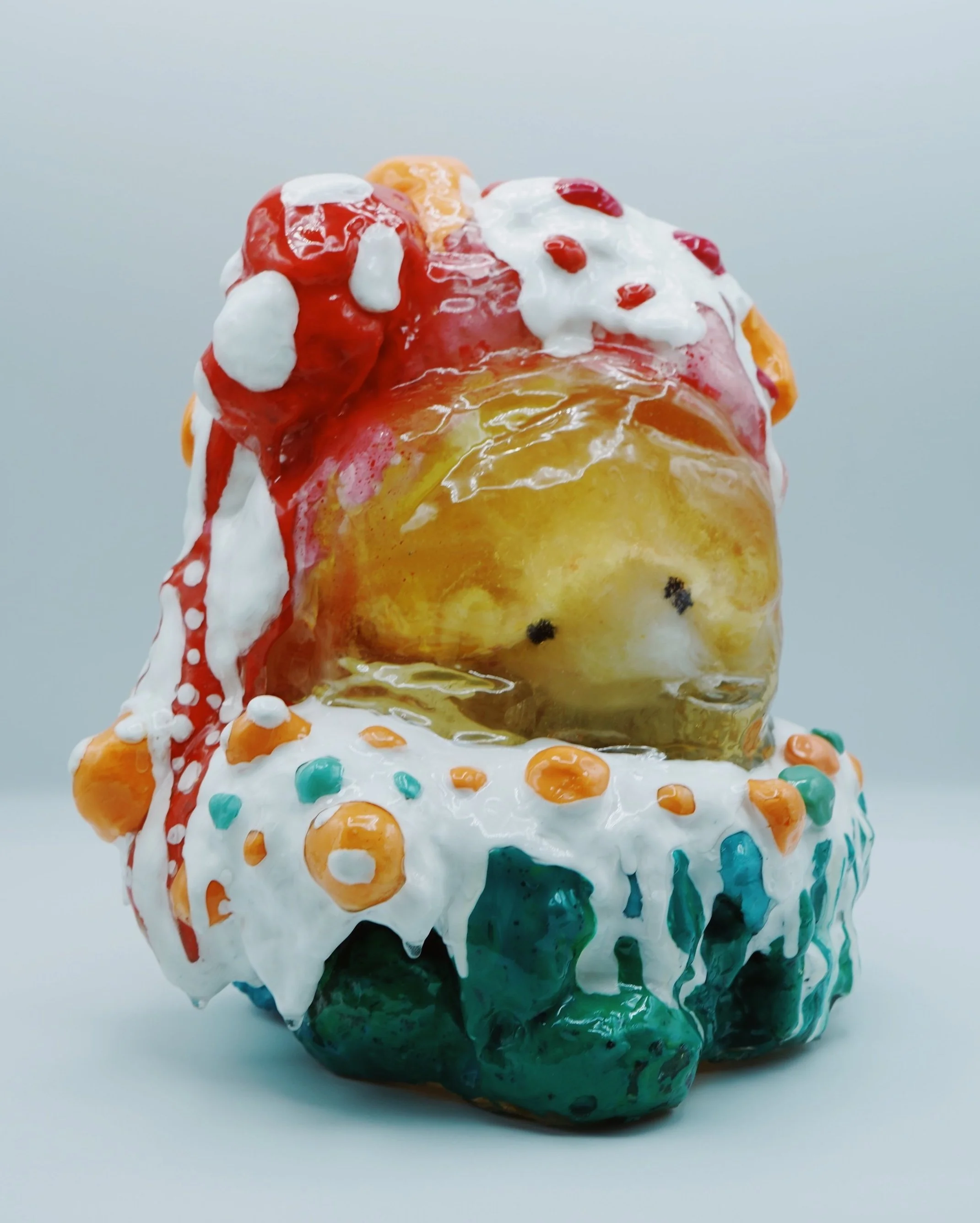 In Happy’s House, artist Sophia Huang encases altered plush figures in resin, foam, and paint to expose how memory distorts emotional truth, transforming familiarity into something fragmented, unreliable, and deceptively preserved.