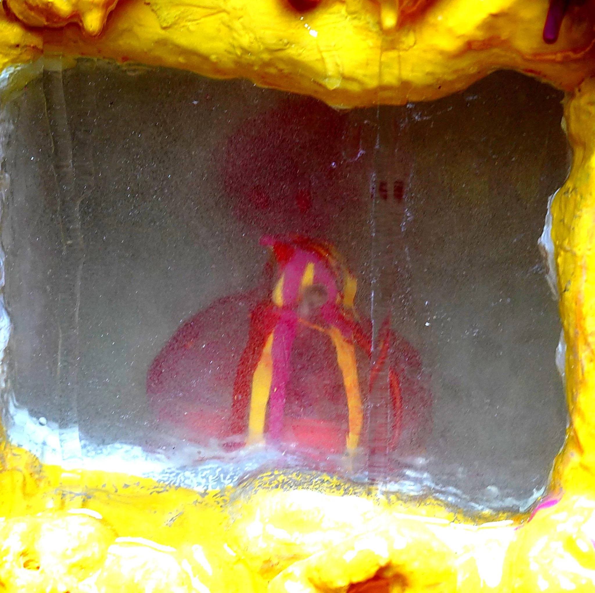 Detail view of Volcanic Shelf sculpture by contemporary artist Sophia Huang, mixed media shelf sculpture with resin, paint, and embedded objects, abstract melting form