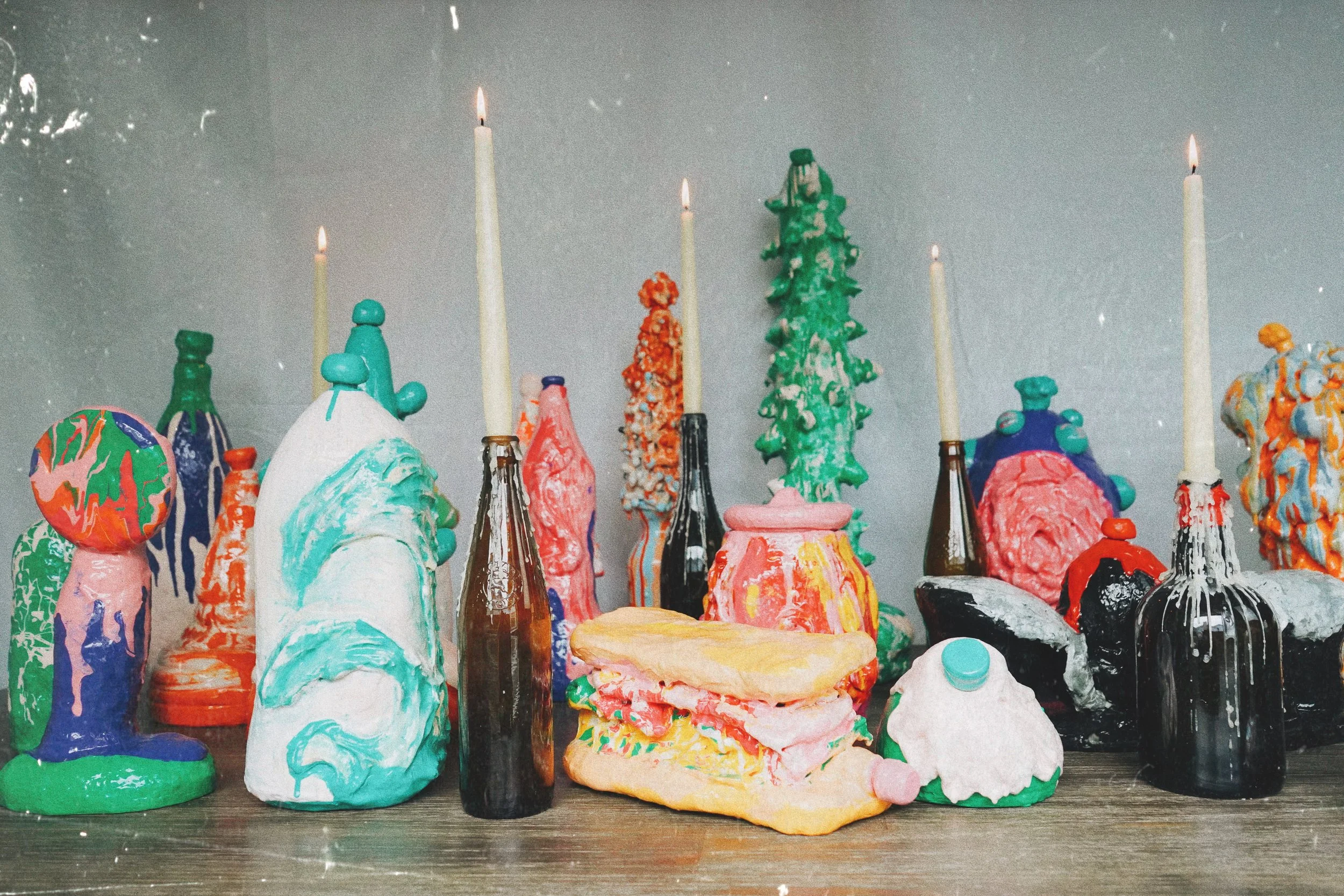 Ash Banquet installation by contemporary artist Sophia Huang, mixed media sculpture installation with resin forms, painted objects, and candles arranged in ceremonial still life