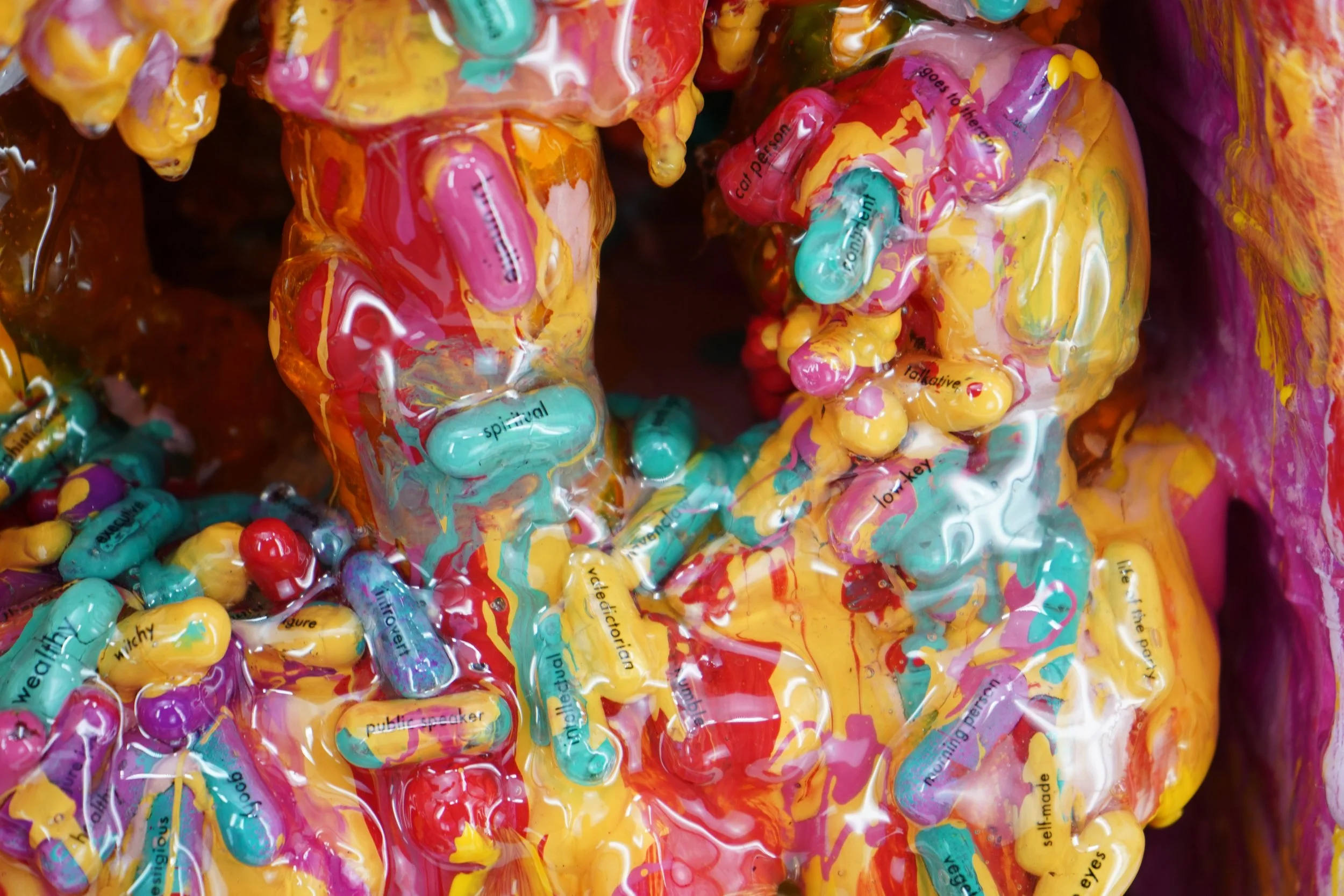 Detail view of melting medicine cabinet sculpture by contemporary artist Sophia Huang, mixed media sculpture with resin, paint, and embedded pill capsules