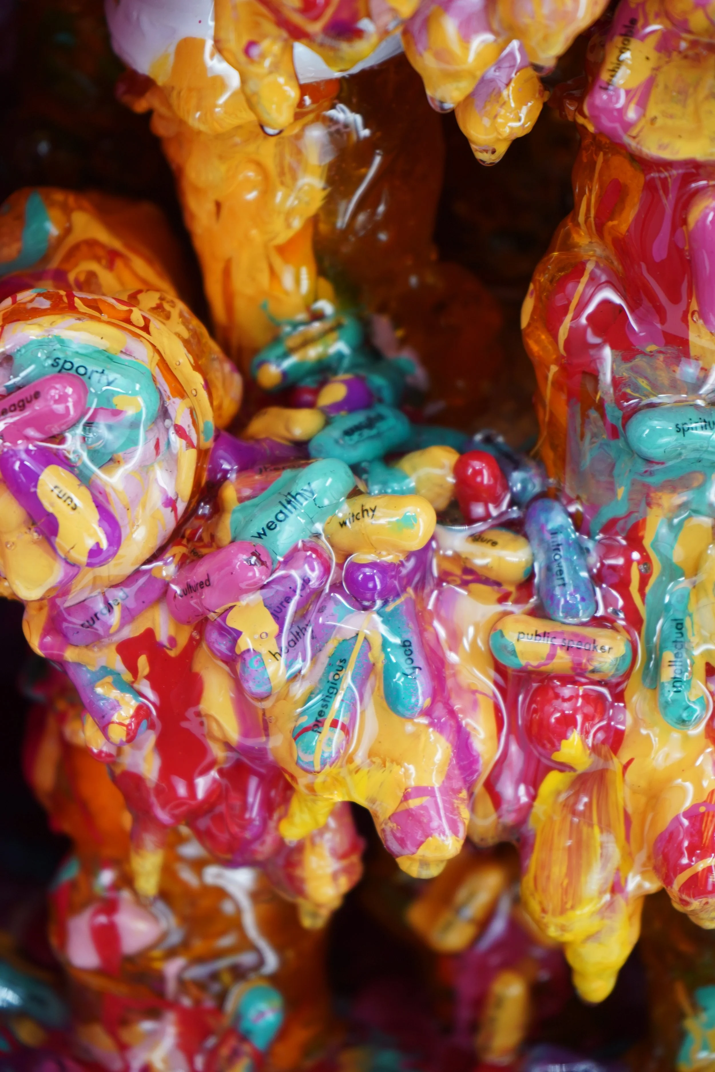 Detail view of melting medicine cabinet sculpture by contemporary artist Sophia Huang, mixed media sculpture with resin, paint, and embedded pill capsules