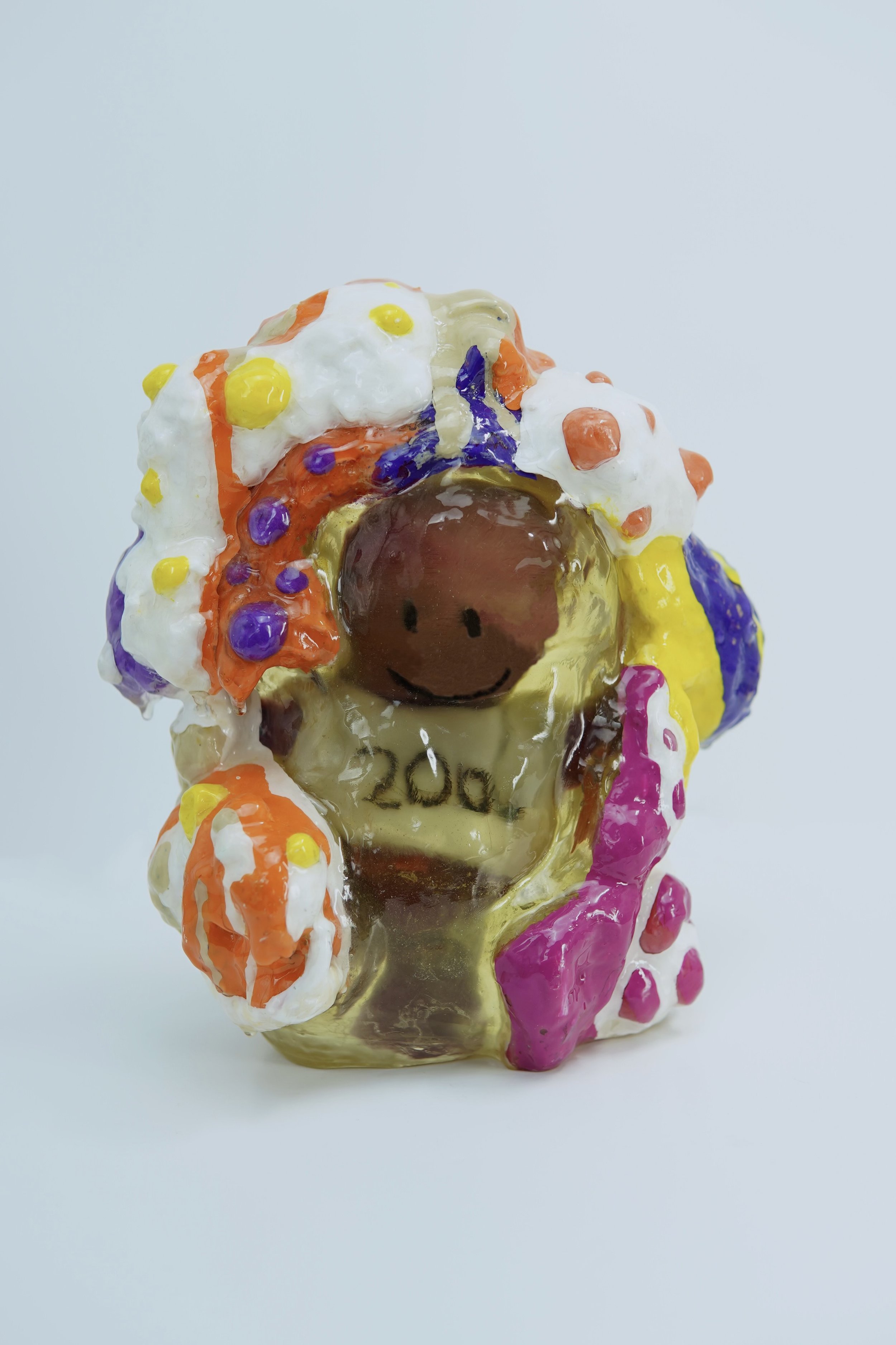 In Happy’s House, artist Sophia Huang encases altered plush figures in resin, foam, and paint to expose how memory distorts emotional truth, transforming familiarity into something fragmented, unreliable, and deceptively preserved.