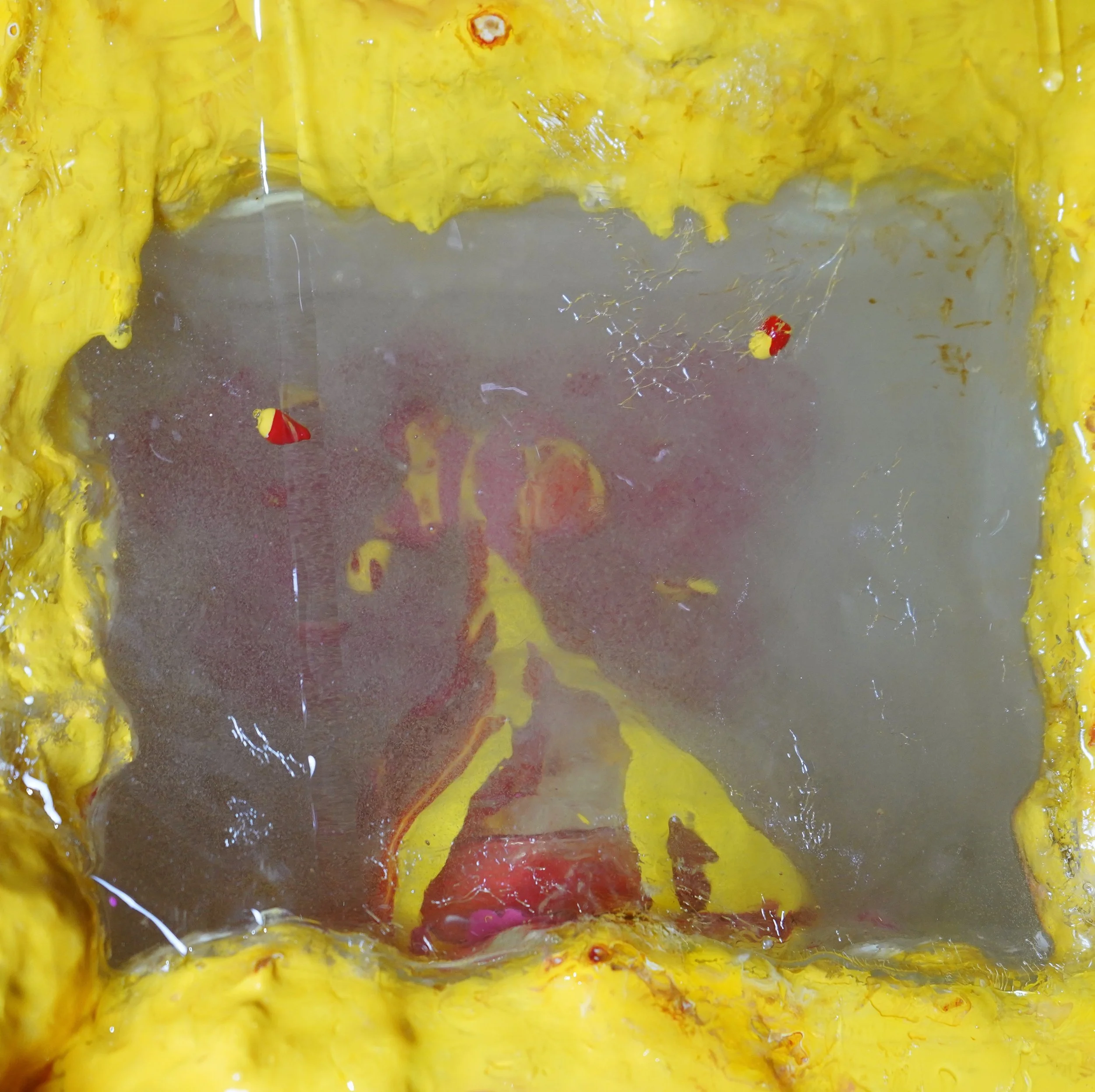 Detail view of Volcanic Shelf sculpture by contemporary artist Sophia Huang, mixed media shelf sculpture with resin, paint, and embedded objects, abstract melting form