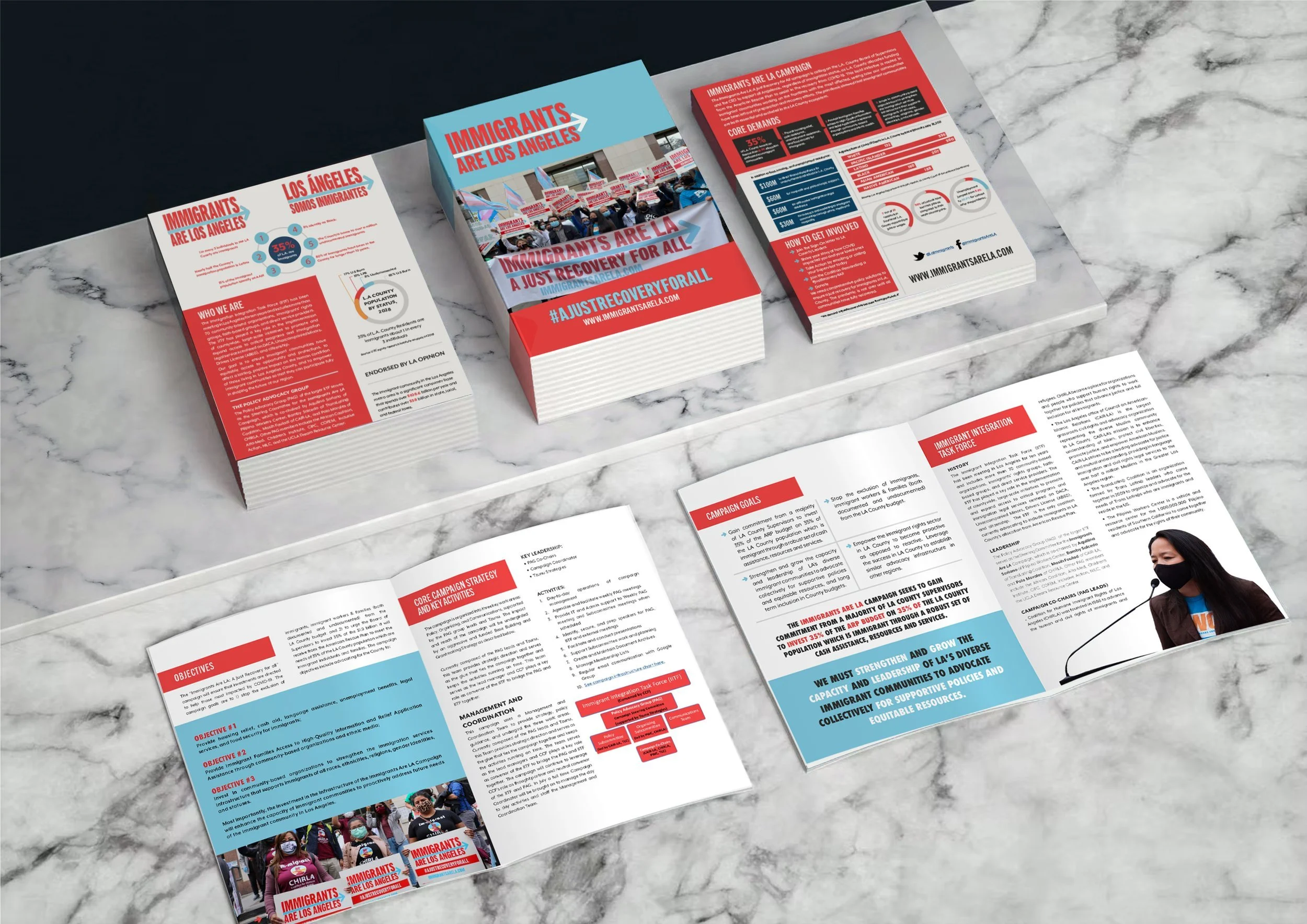 Brochures and pamphlets on a marble table advocating for immigrant rights and showcasing campaign information for Immigrants Are La Angeles.