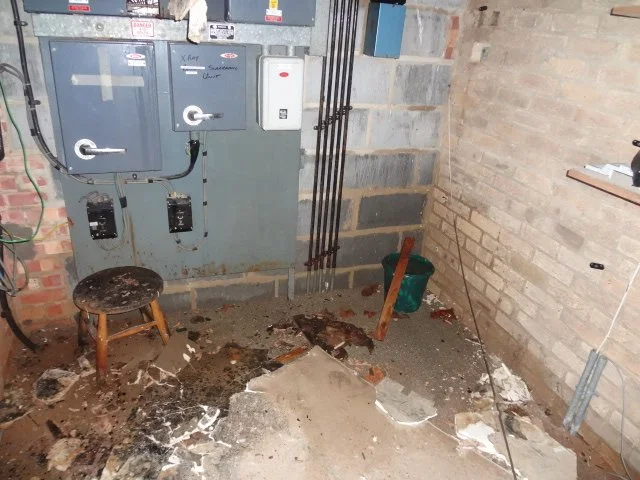 Water damage and debris in plant room caused by leaks affecting electrical equipment.