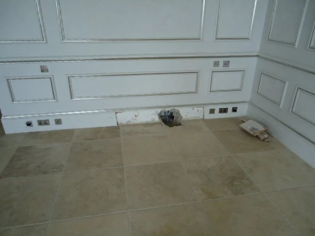 Removal of wall finishes for the survey of damp and pipework.