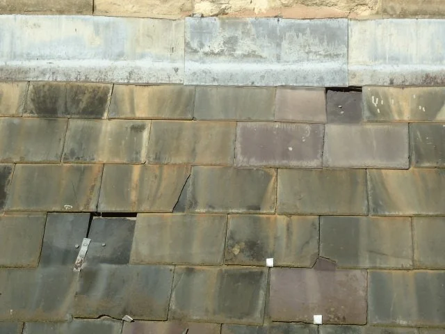 Missing and slips natural slate roof - roof survey.