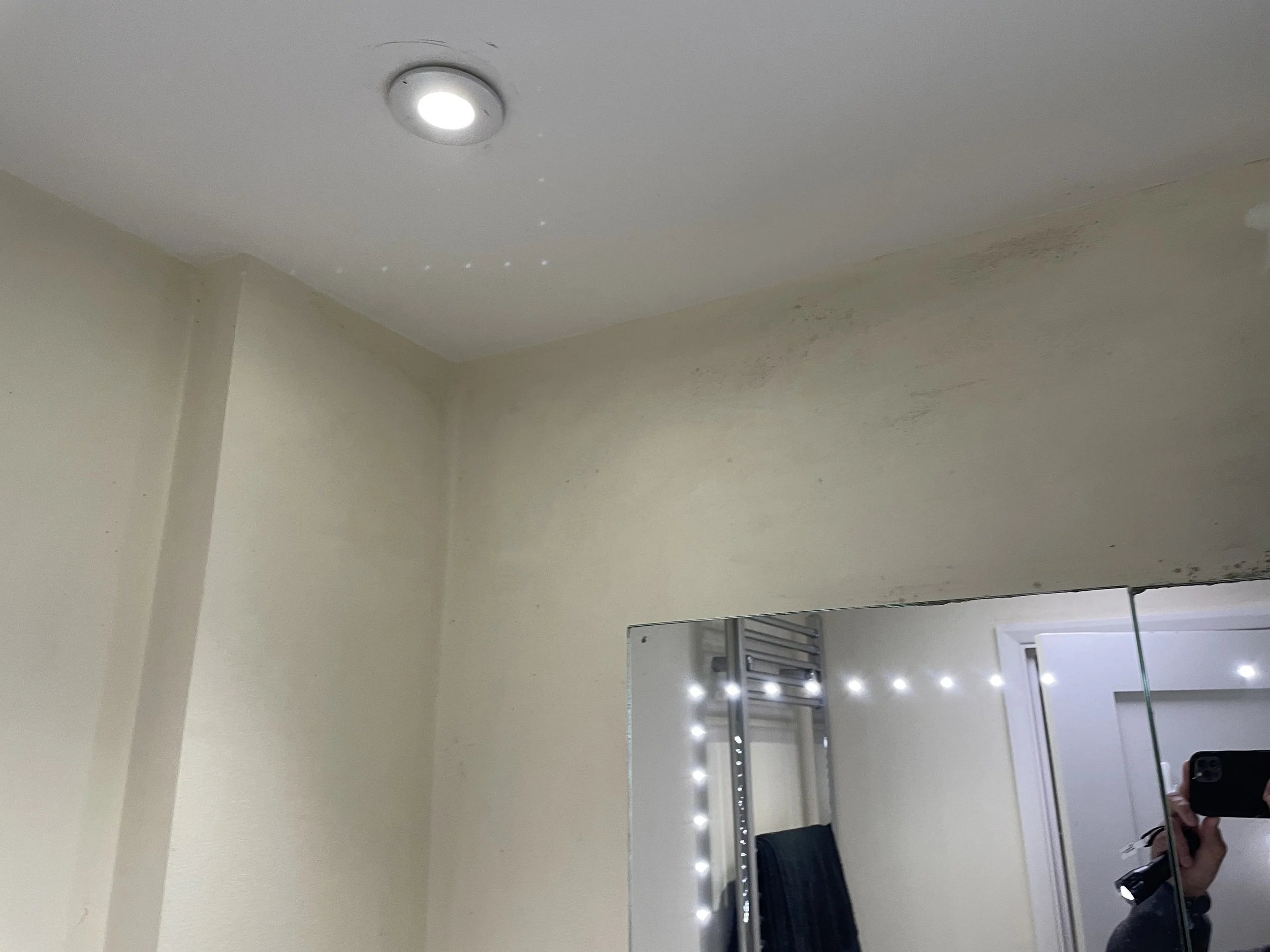 Condensation and mould staining on upper bathroom wall from poor extract ventilation – damp and mould compliance inspection, Milton Keynes