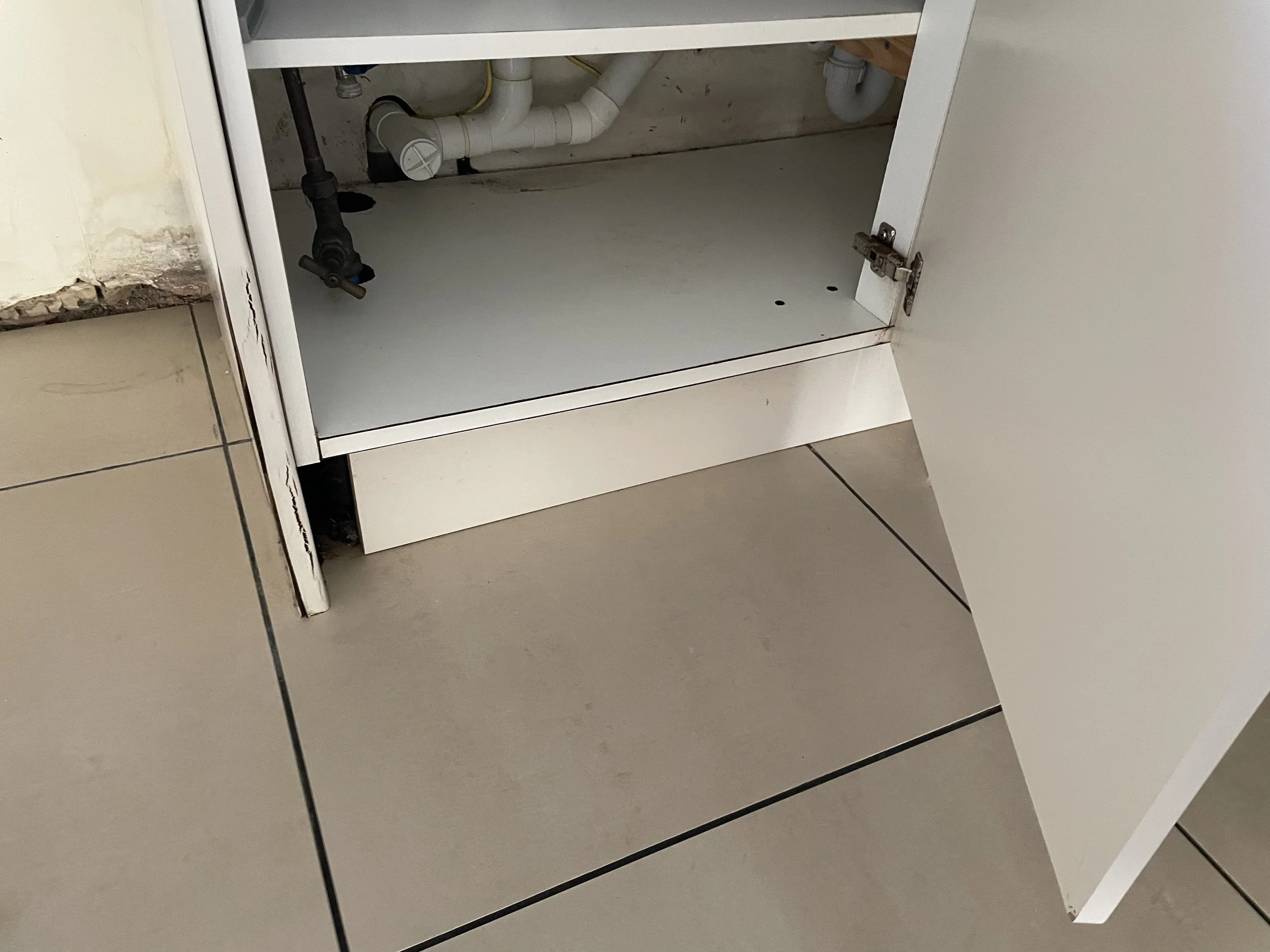 Under-sink leak in kitchen unit contributing to internal humidity and surface dampness – secondary moisture source identified during Awaab’s Law compliance survey, Milton Keynes