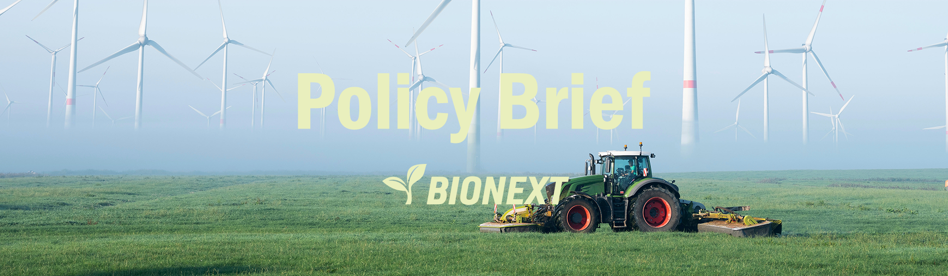 farmer mows grass near wind turbine farm in oastfriesland on misty summer morning_AdobeStock