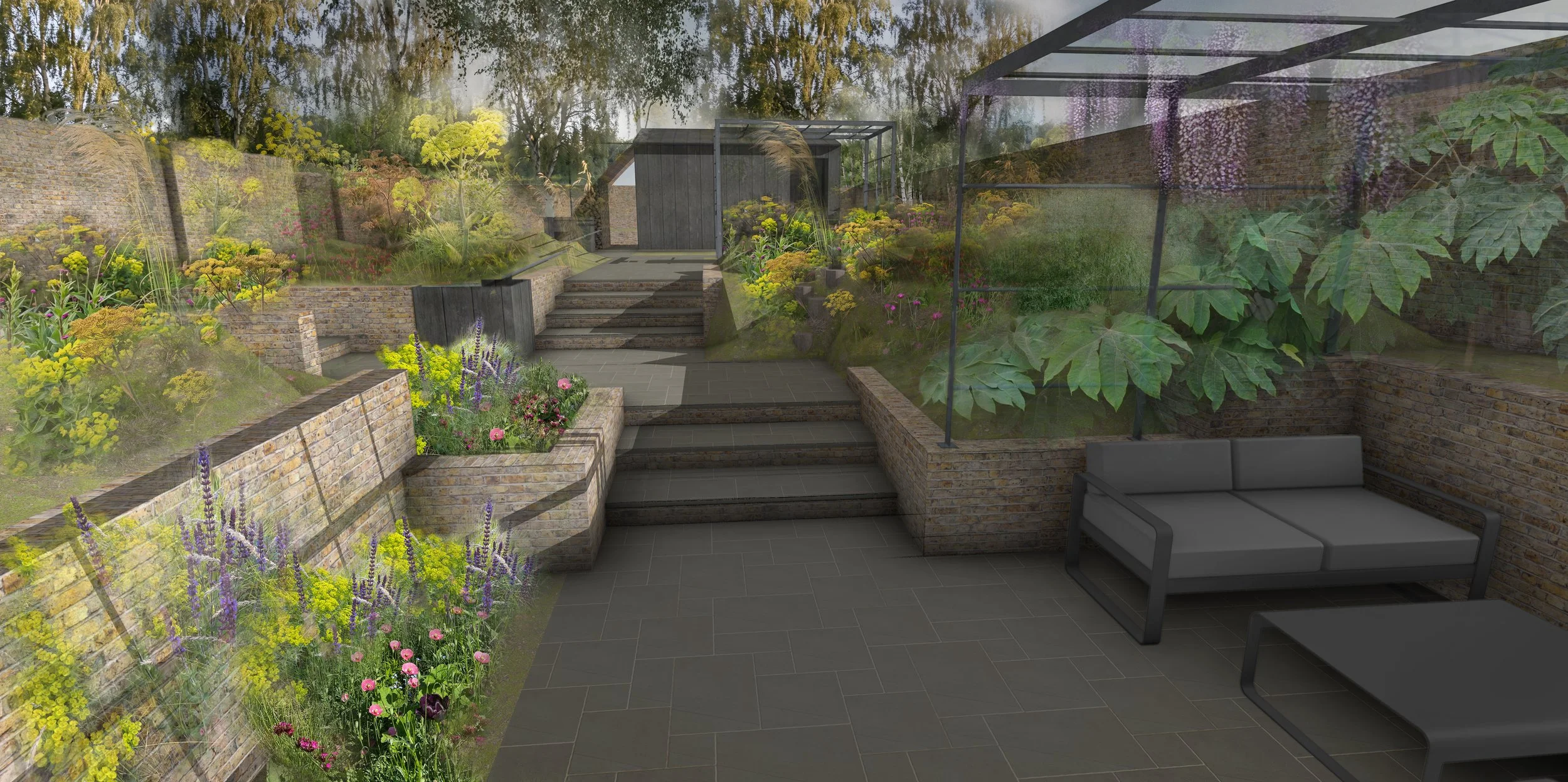 A garden with stone steps, brick walls, green plants, and blooming flowers. There is a gray outdoor sofa on a tiled patio.