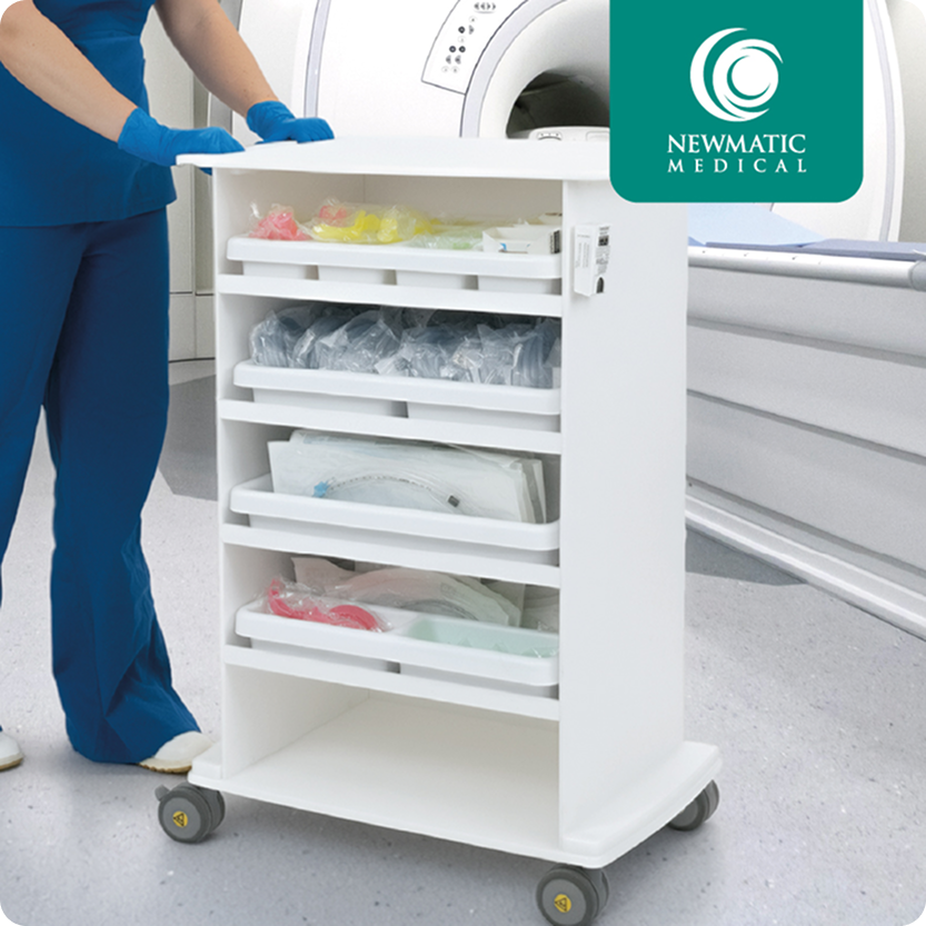 Medical supplies and equipment stored in a white cart on wheels in front of an MRI machine at a healthcare facility.