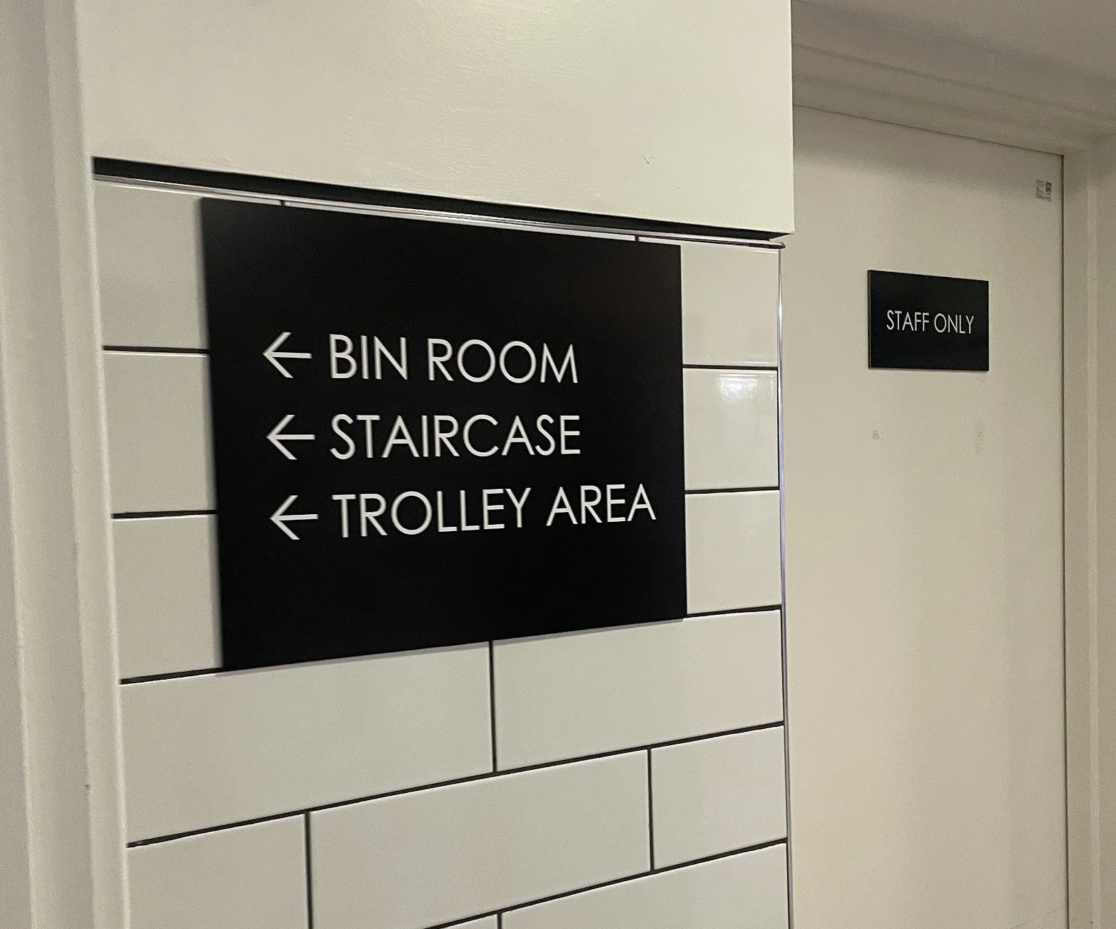 White Text on Black Metal Wayfinding 2.webp