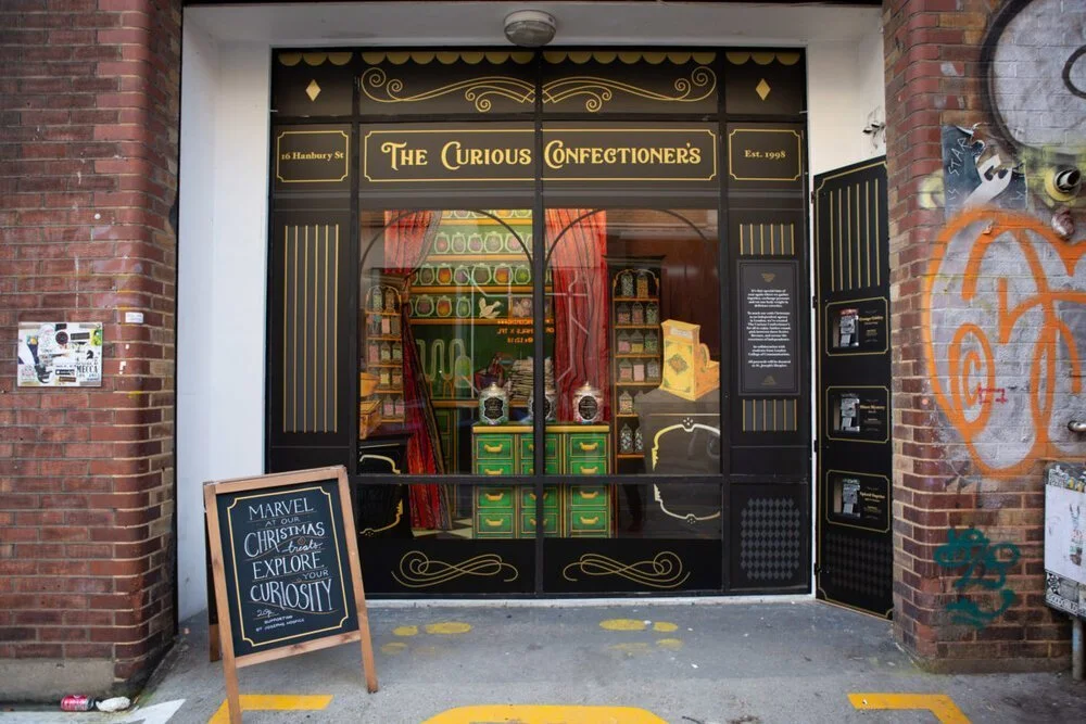 The Curious Confectioner's Window Graphics.webp