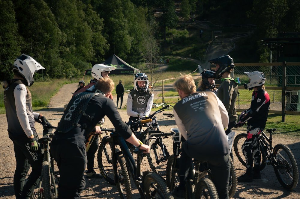 Grupp av personer med cyklar och hjälmar, samlade på Vallåsen Bike Park.