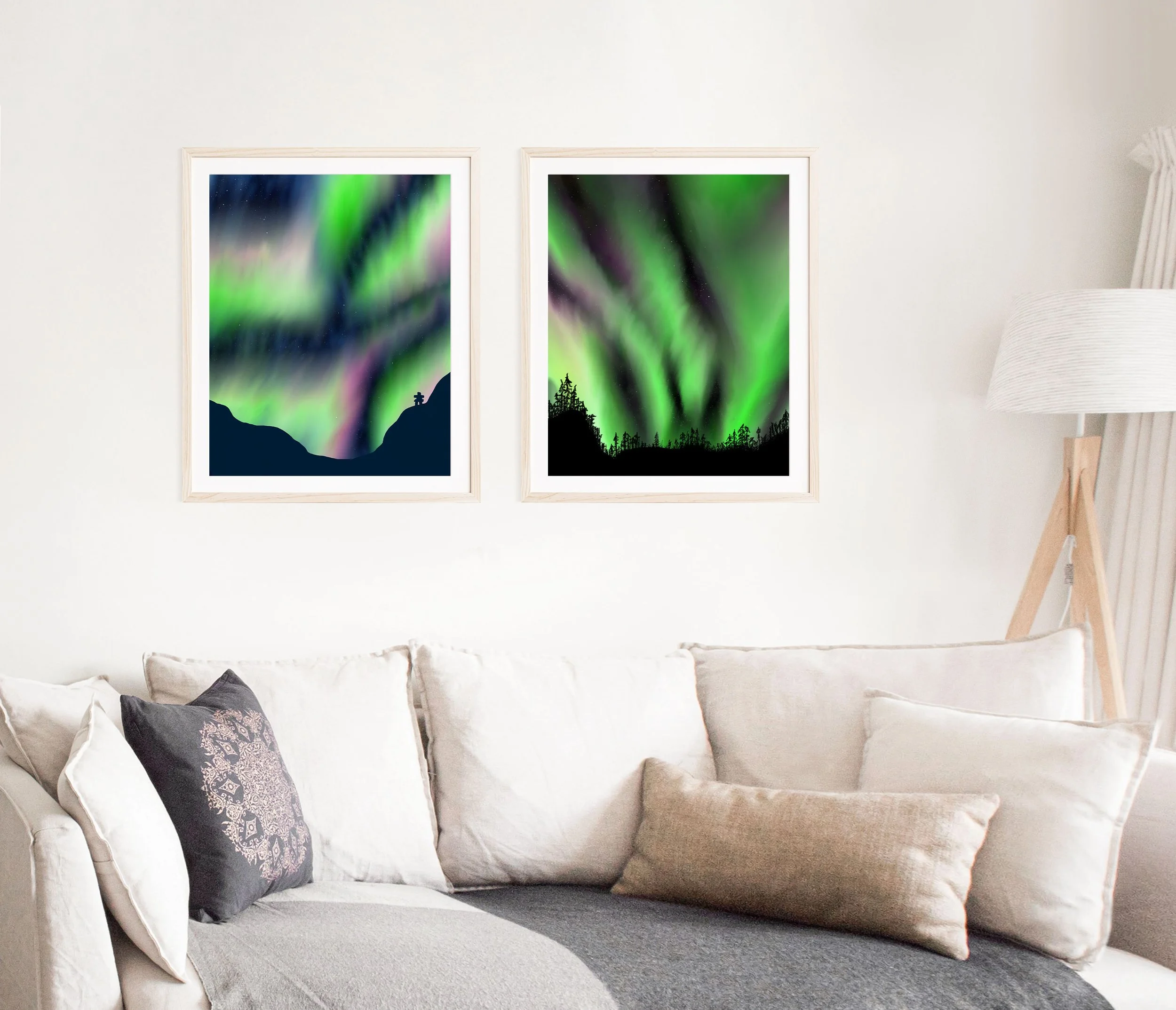 Two prints by hi, love. greetings are shown on a living room wall. The prints are of original digital paintings of the Northern Lights.  The greens and pinks are brilliant against a dark night sky background.