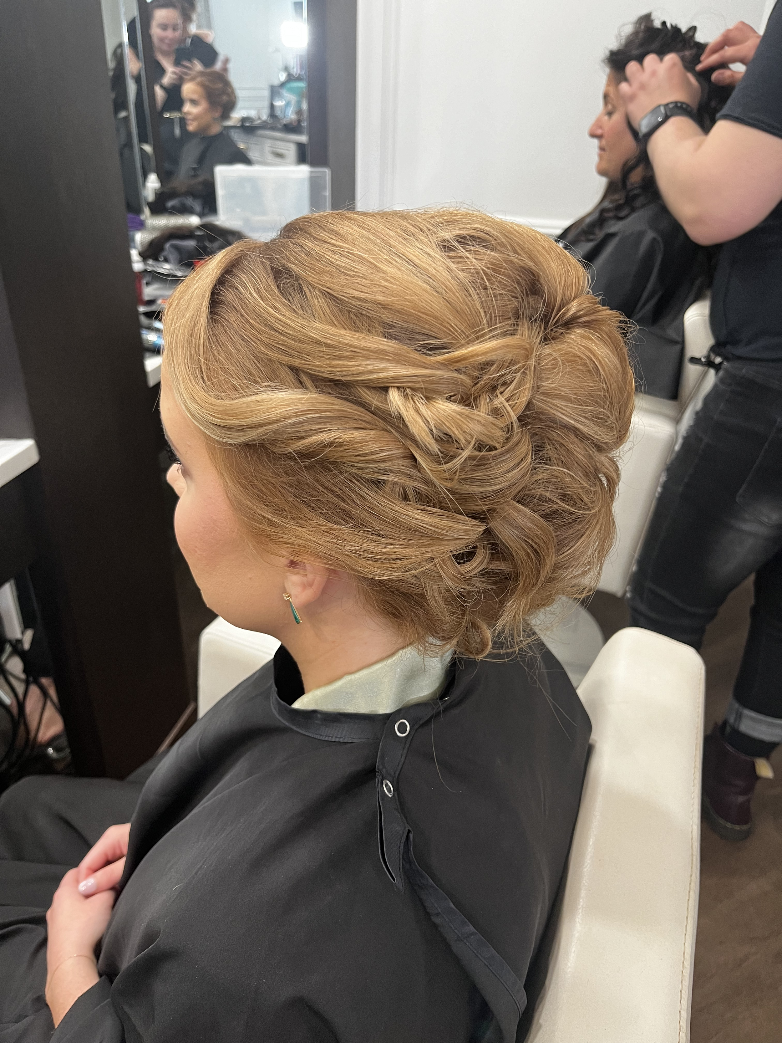 Woman with styled updo at hair salon
