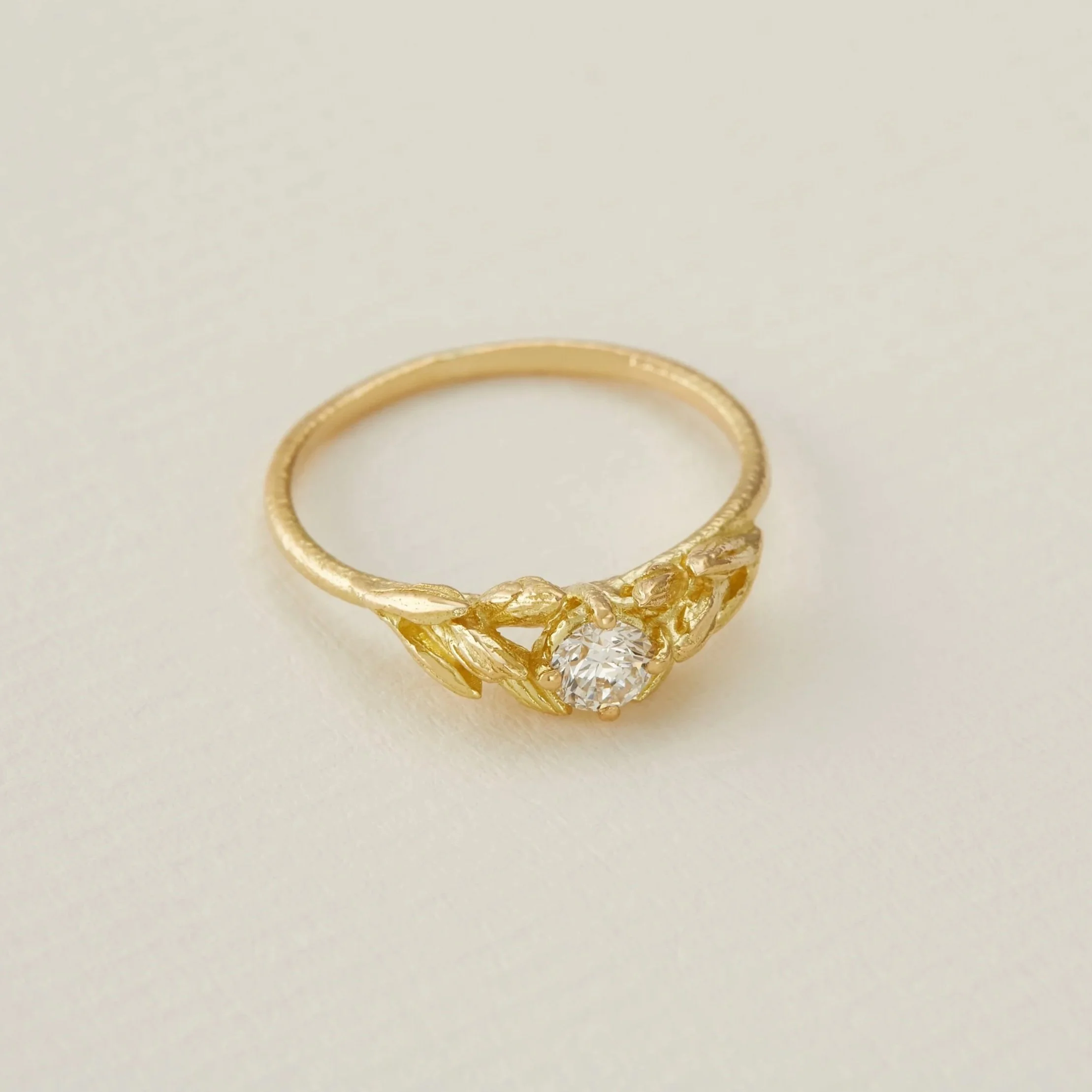 Alex Monroe Wild Grass Seed Diamond Ring in 18ct Fairmined yellow gold with a 0.25ct G VS1 round brilliant cut diamond, size P in stock.