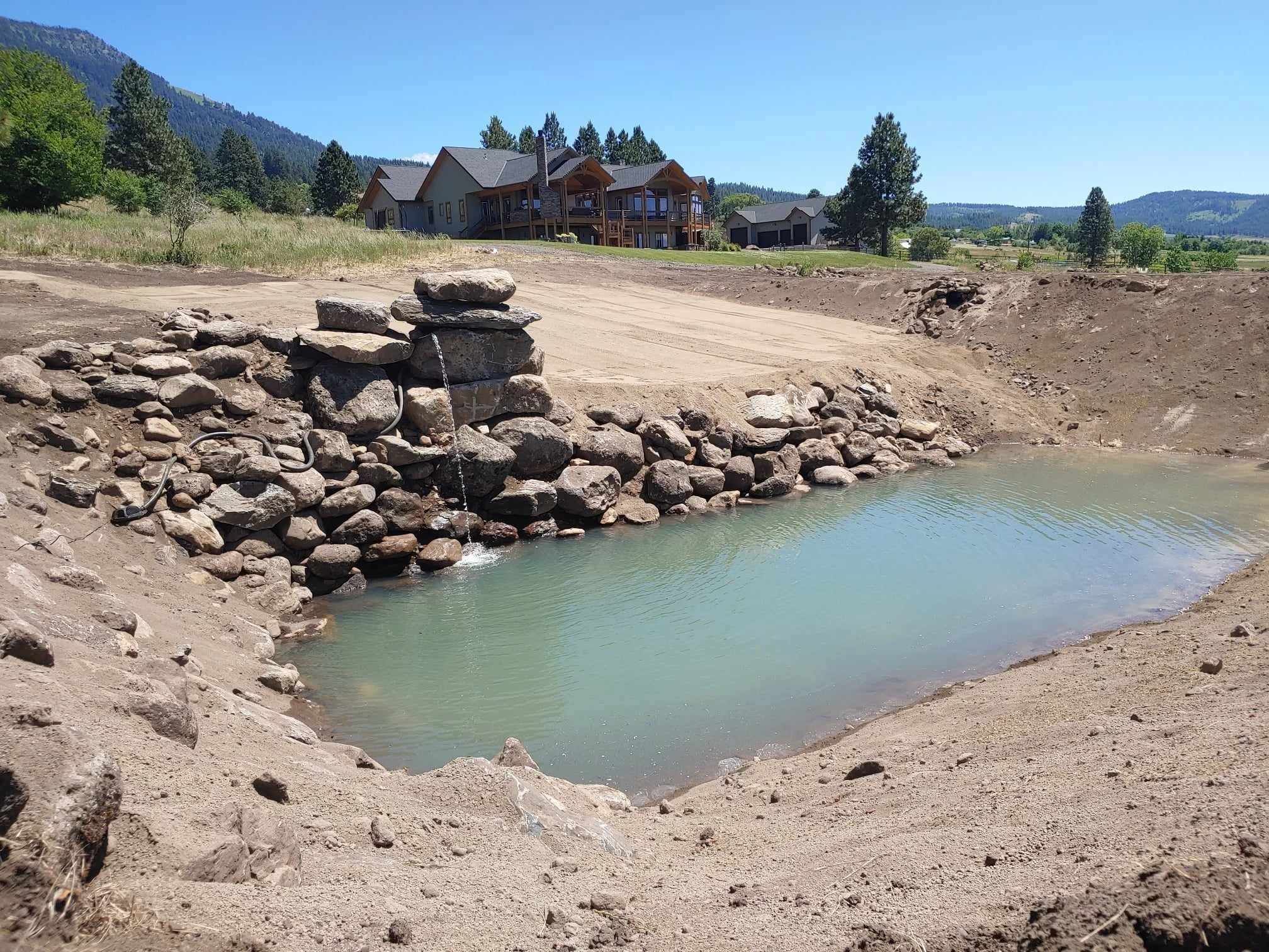 Swimming Pond w/ diving rocks and sand beach