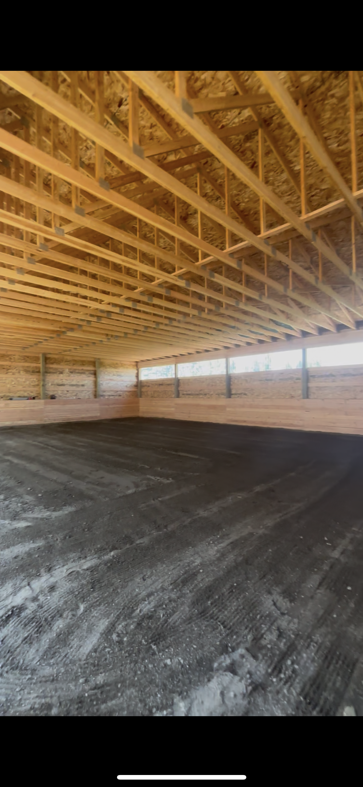 Rock base and sand grading for riding arena