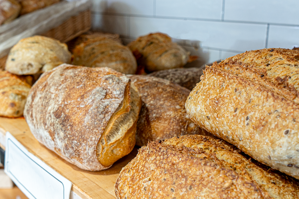 Selection of fresh baked artisan breads on display in the bakery.