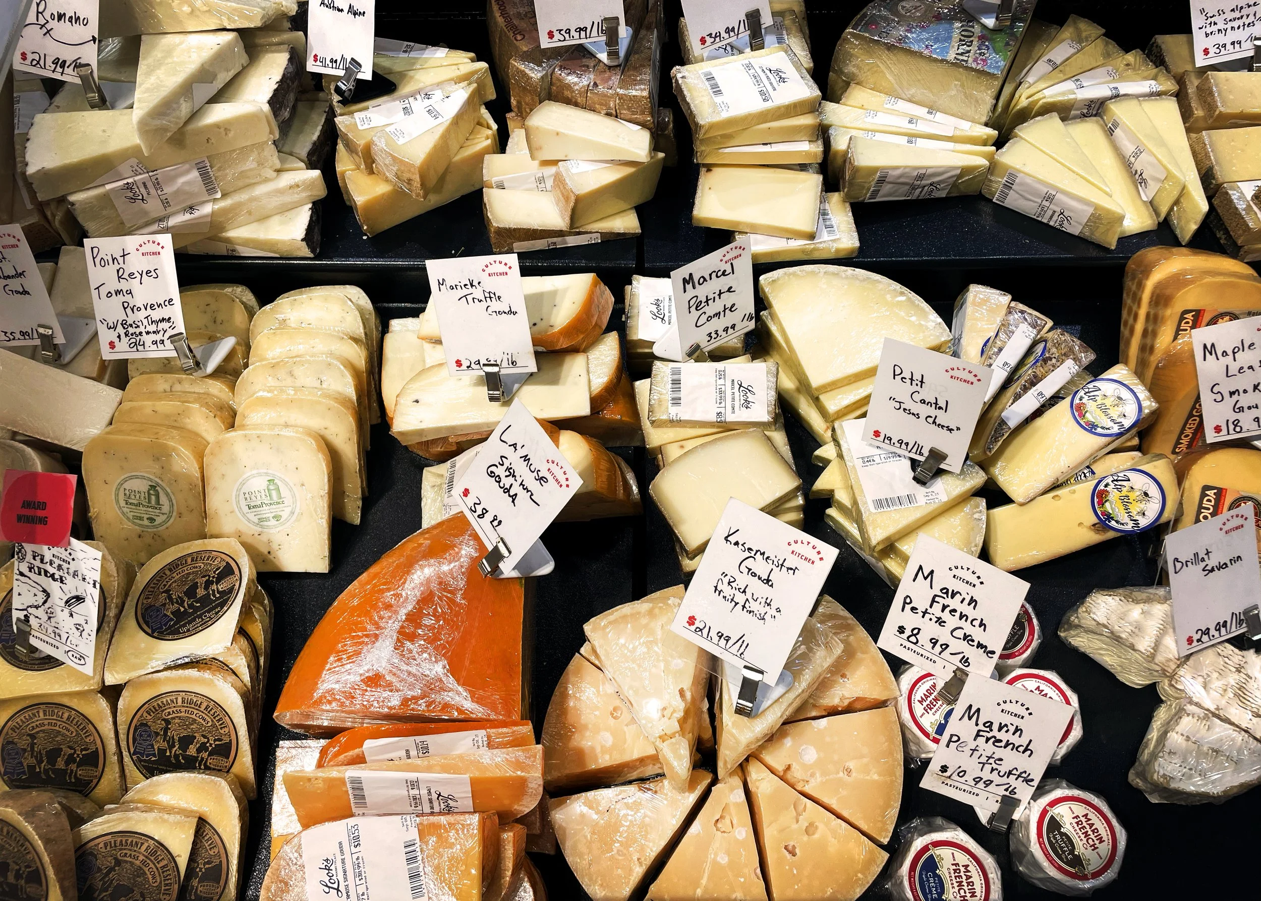 Artisanal cheese in a cheese case inside Look's Marketplace.