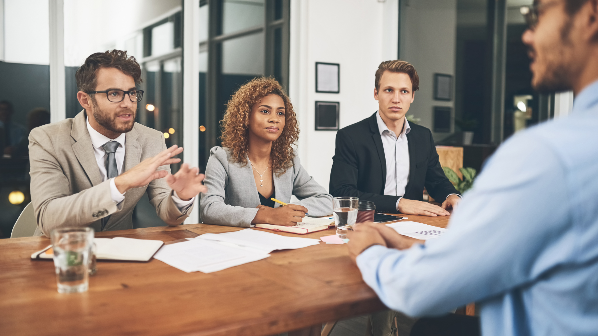 Homebuyers meeting at a table to review the costs of owning a home in California