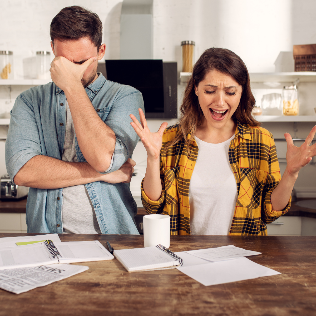 Stressed couple reviewing bills at home: collections can hurt your credit for years