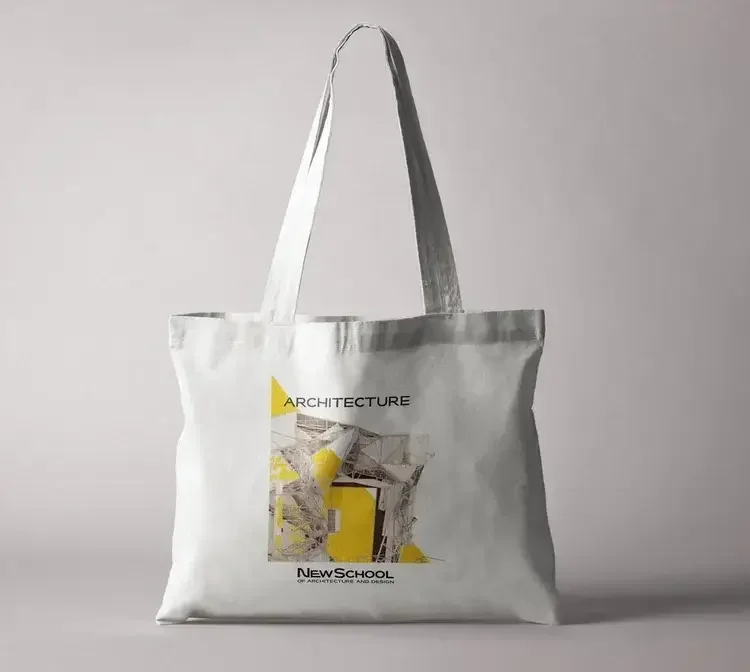 White tote bag with handles and architectural design on the front.