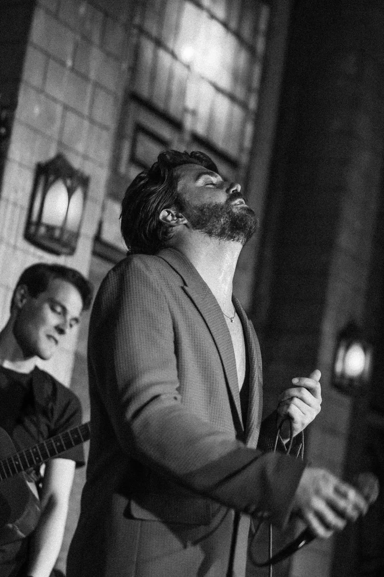 Cornelius Versa singing on stage in Los Angeles