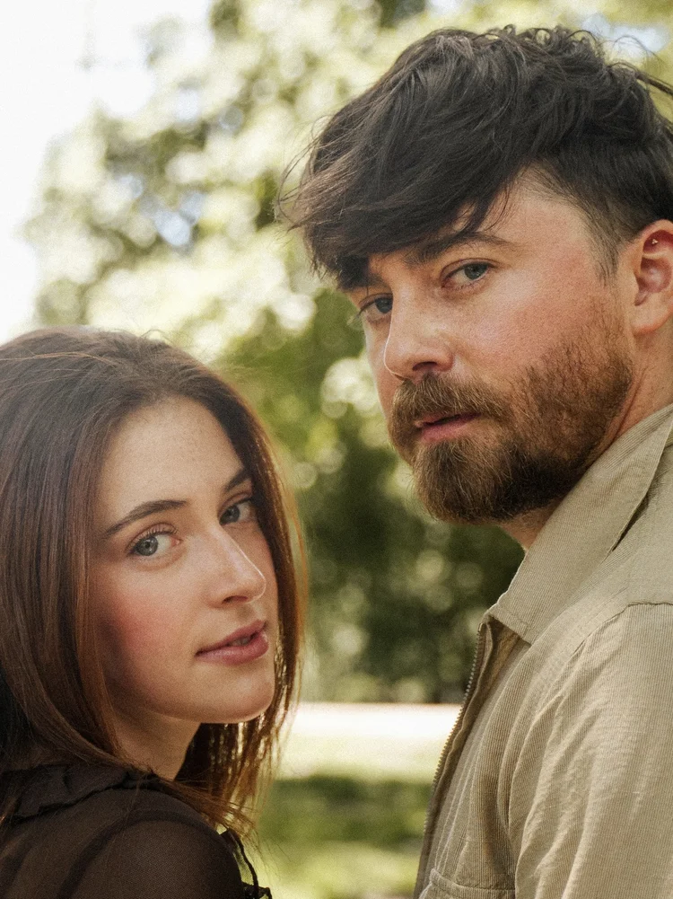 Cornelius Versa and Juliet Perel outdoors in a promotional photo for Oil and Whiskey
