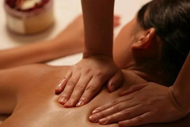 Person receiving a back massage from a massage therapist.