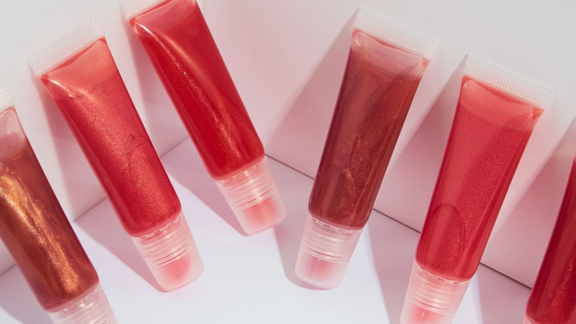 Collection of lip gloss tubes — lip balm hoarders at Tina Rachelle Aesthetics