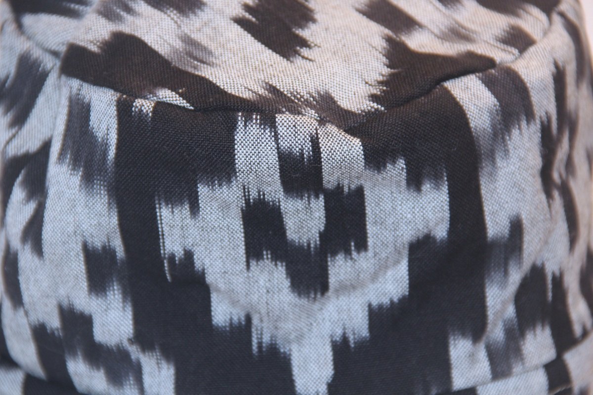 Close up view of pattern on our reversible elevated bucket hat made from Japanese Ikat-dyed fabric in black and ivory pattern. Handmade by Tonya Gross Millinery.