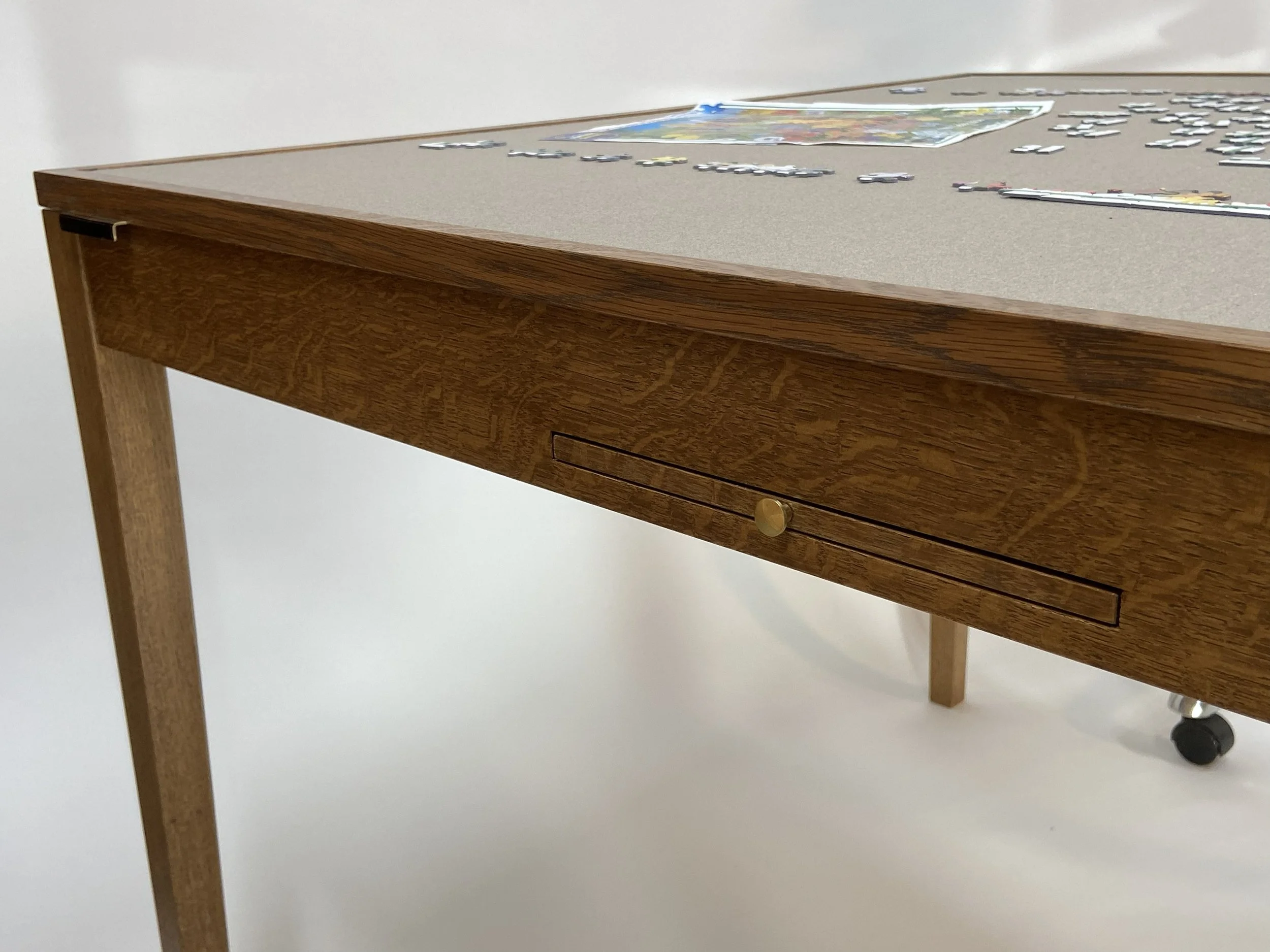 The pull-out trays have matching solid brass knobs.