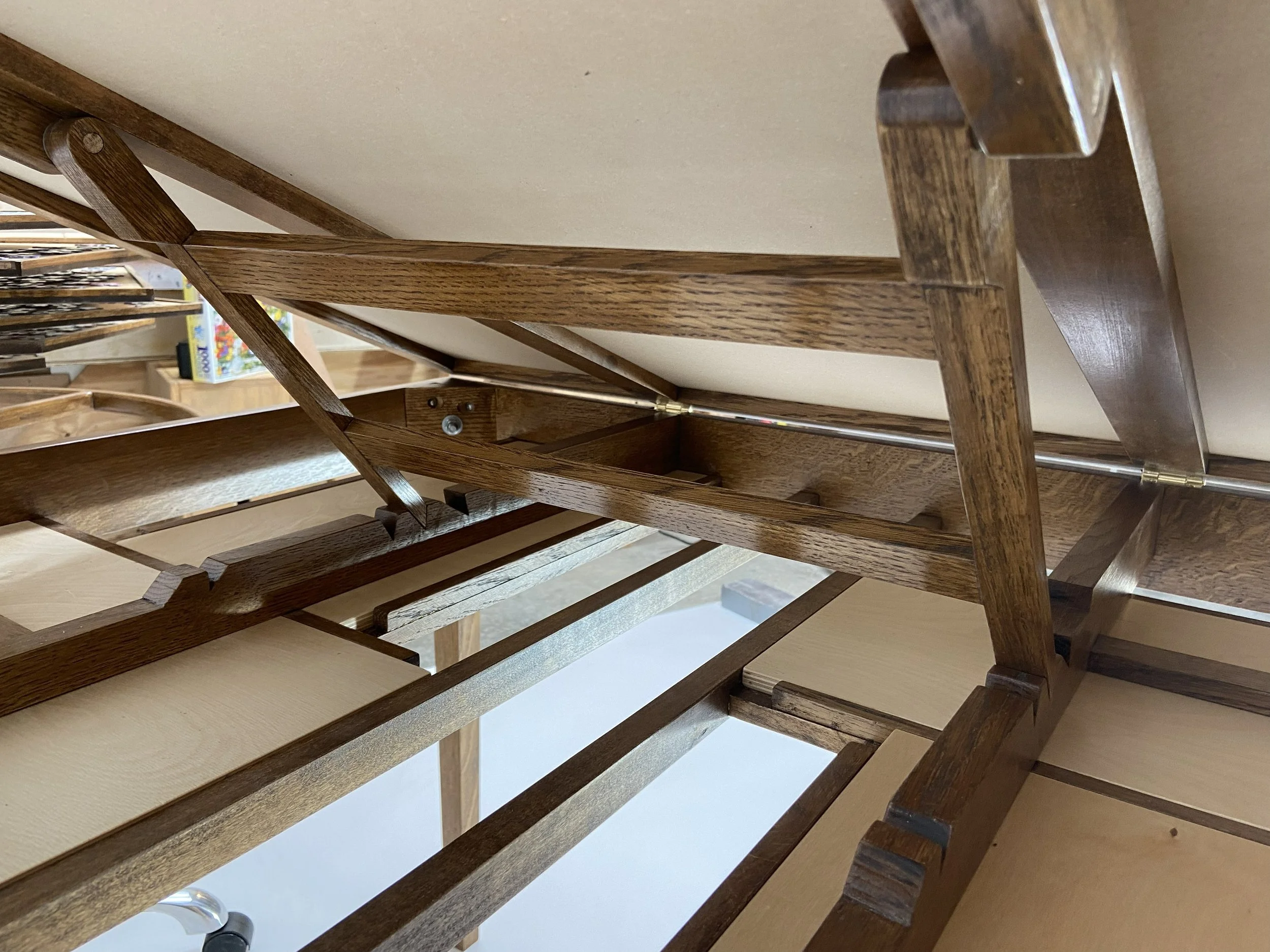 The swing arm drops into notches securely holding the table at the four working angles.